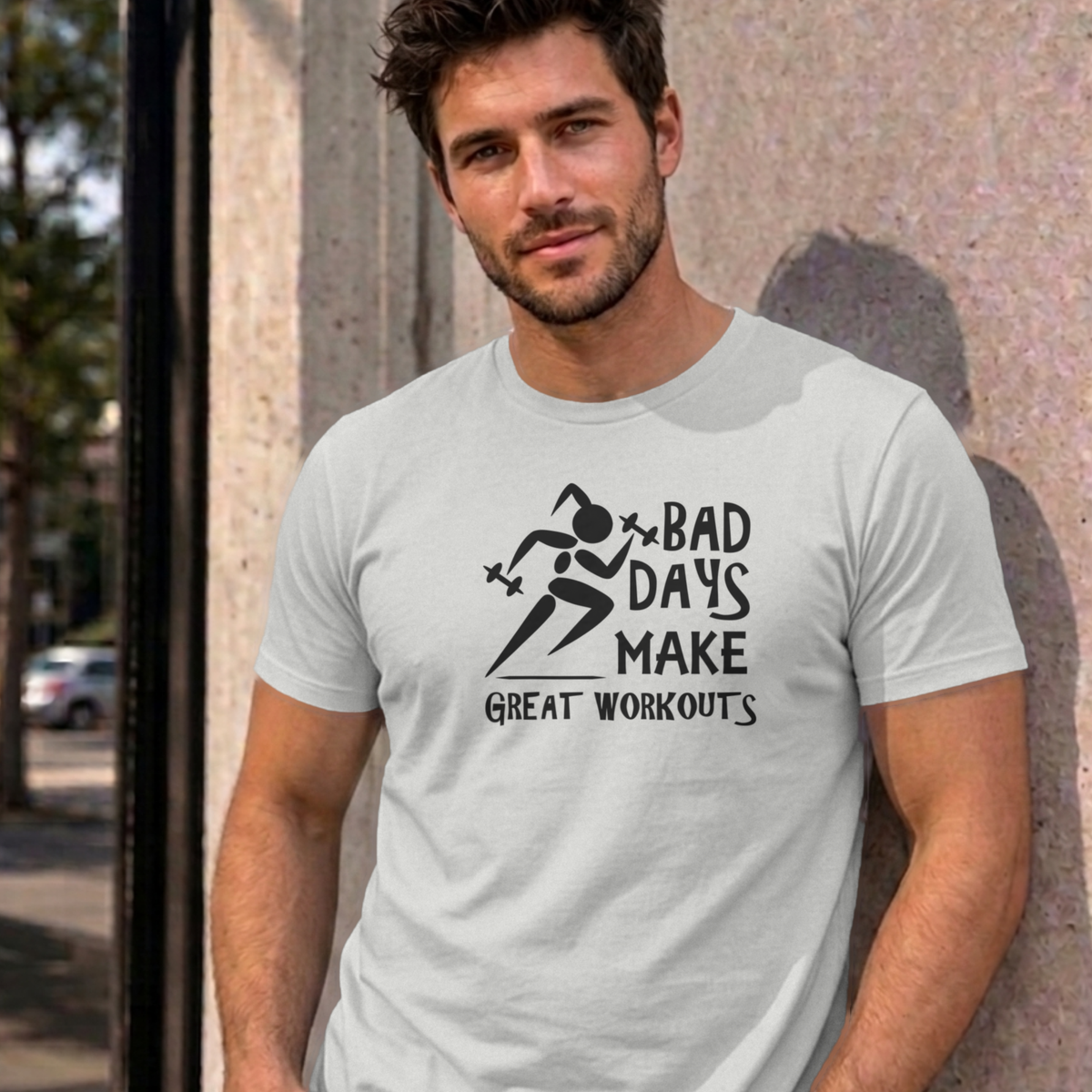 Man wearing the ash Bad Days Make Great Workouts graphic tee