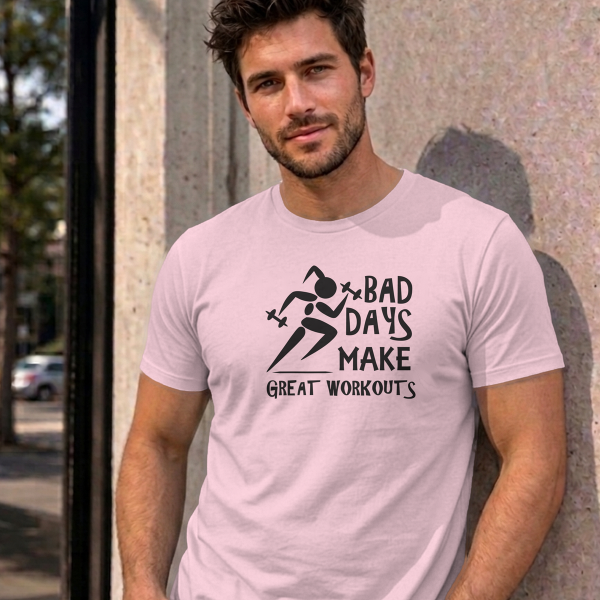 Man wearing the light pink Bad Days Make Great Workouts graphic tee