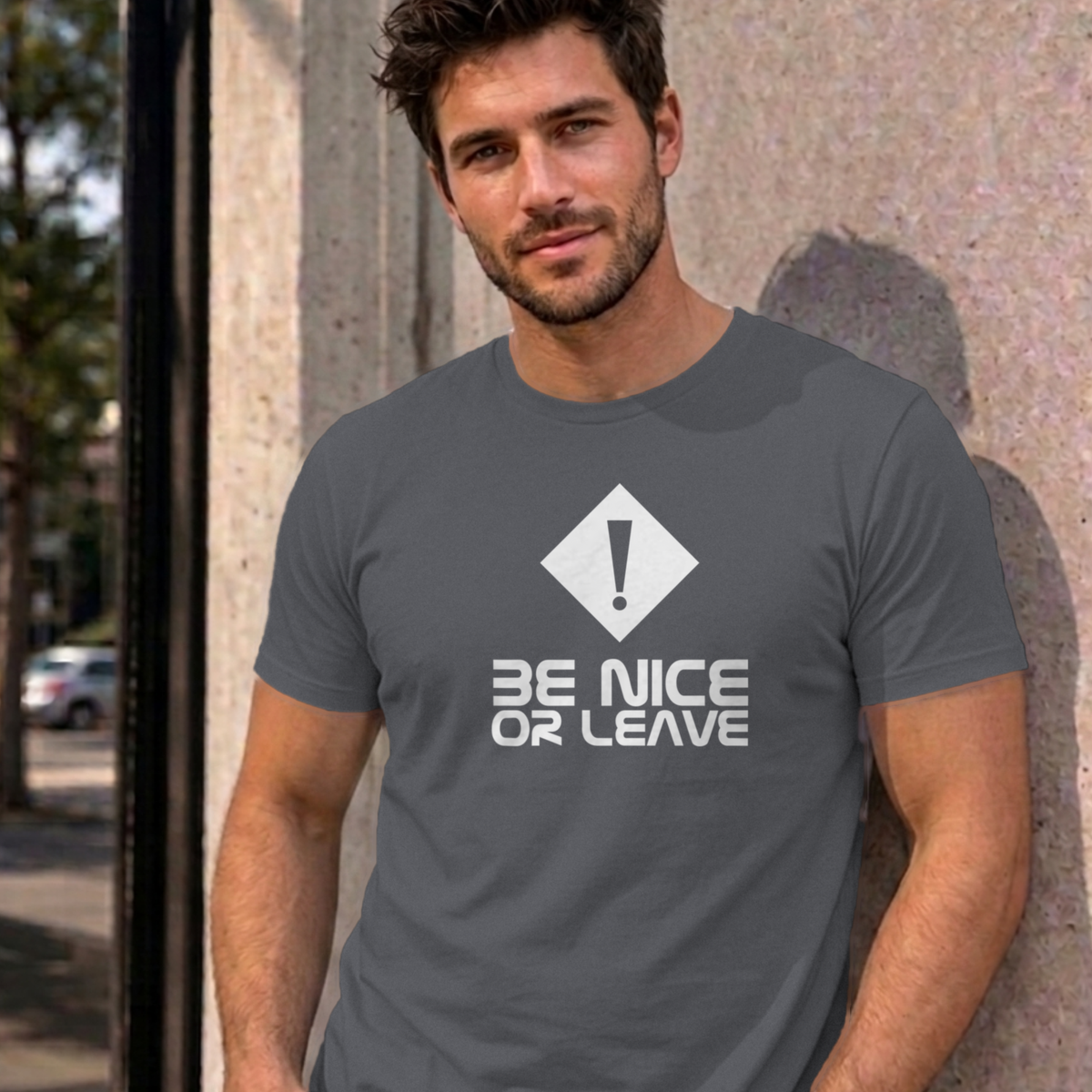 Man wearing the charcoal Be Nice or Leave graphic tee