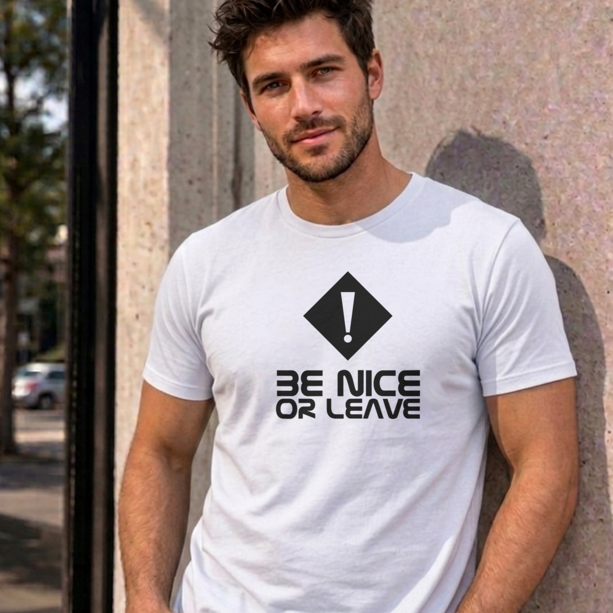 Man wearing the white Be Nice or Leave graphic tee