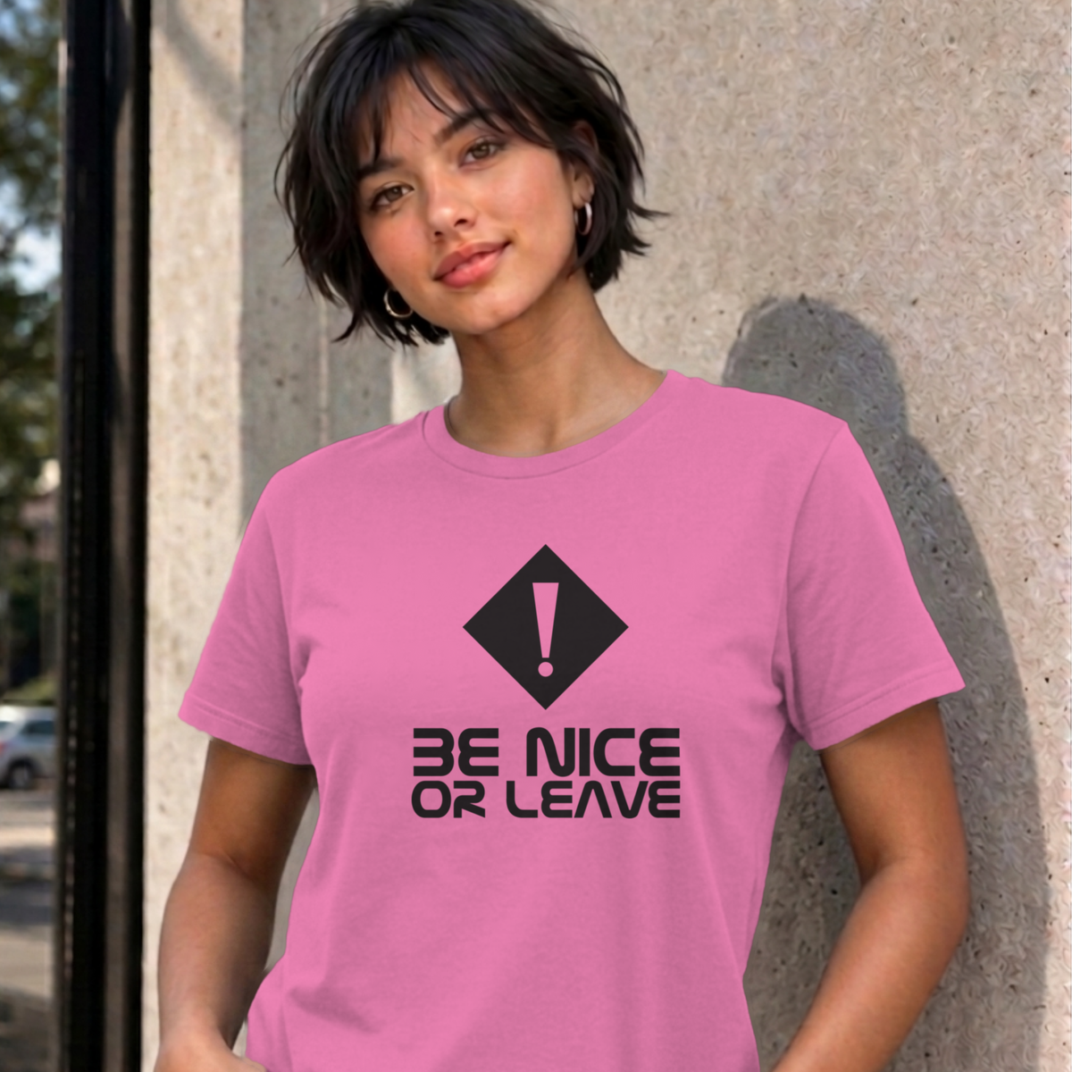 Woman wearing the azalea Be Nice or Leave graphic tee