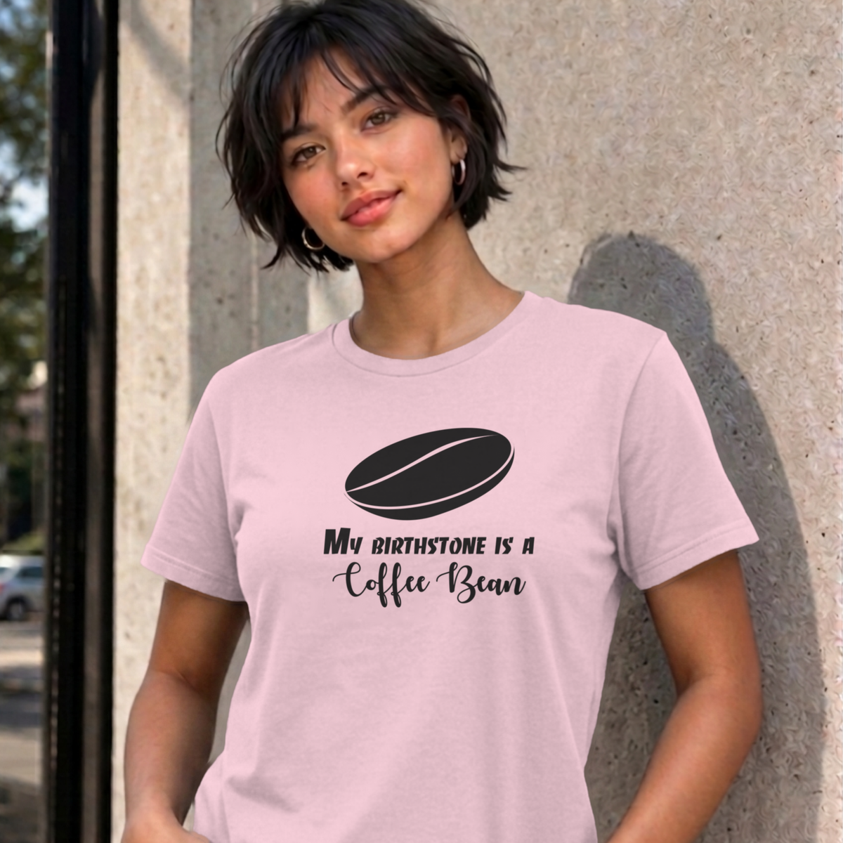 Woman wearing the light pink My Birthstone Is a Coffee Bean graphic tee