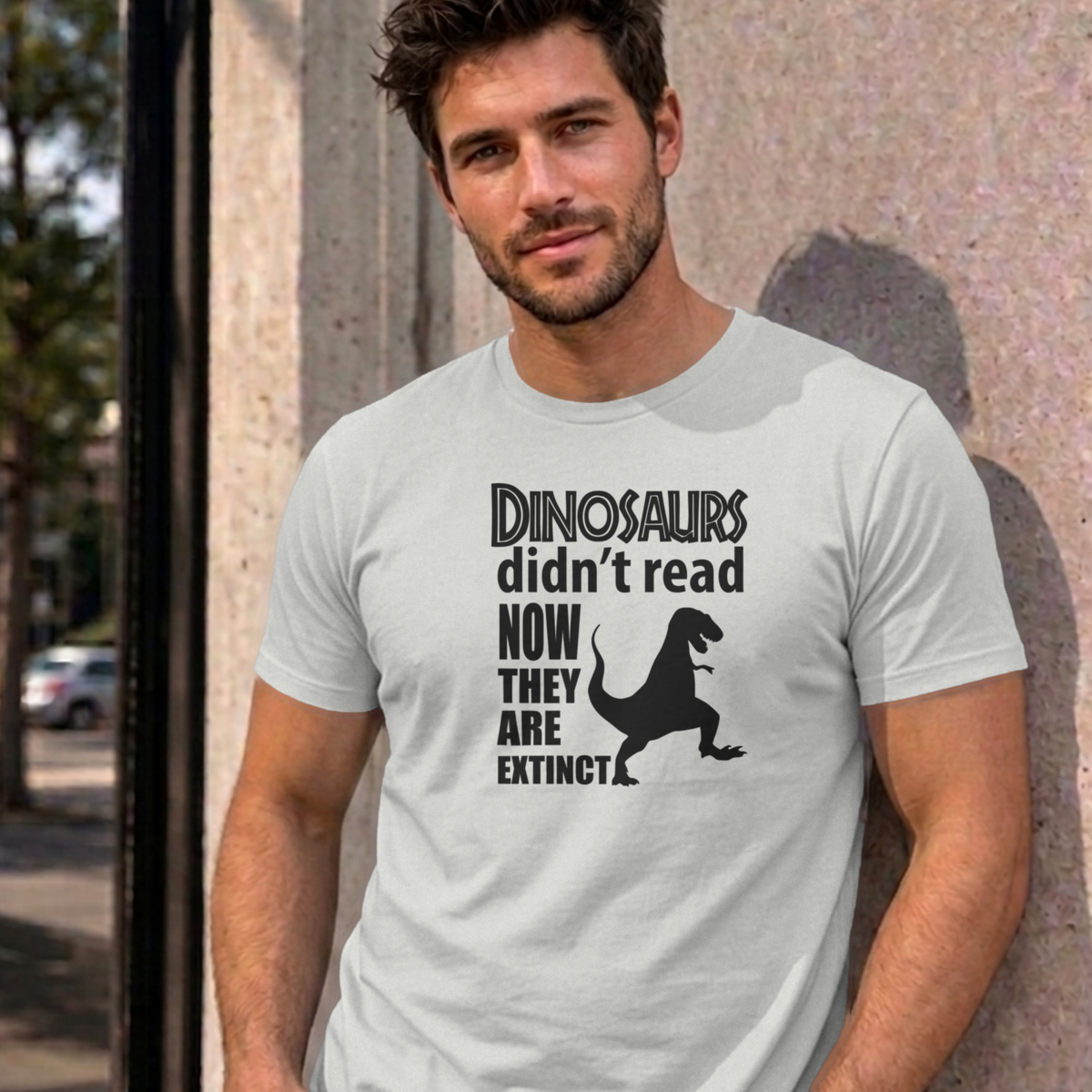 Man wearing the ash Dinosaurs Didn't Read graphic tee