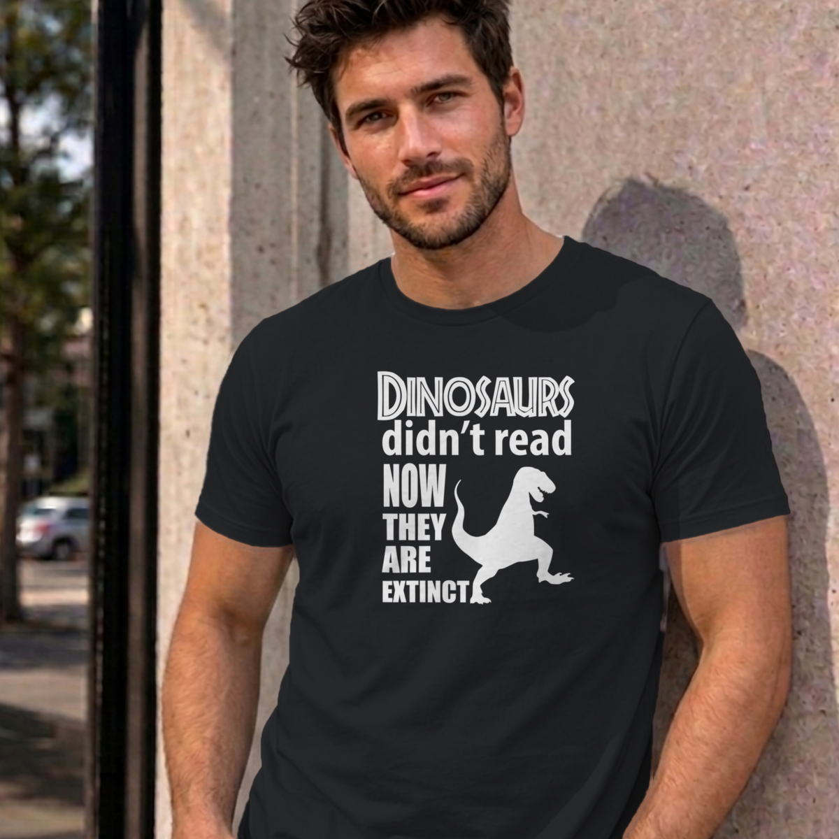 Man wearing the black Dinosaurs Didn't Read graphic tee