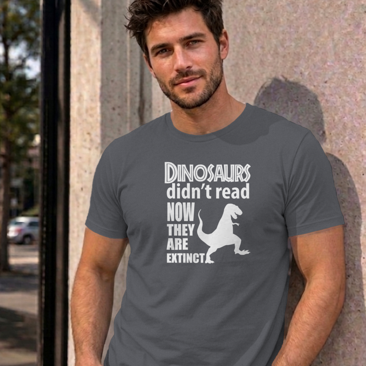 Man wearing the charcoal Dinosaurs Didn't Read graphic tee