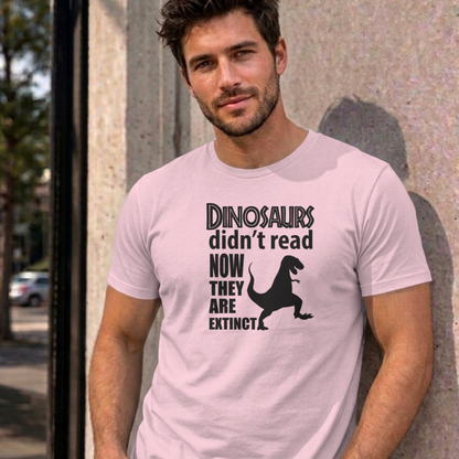 Man wearing the light pink Dinosaurs Didn't Read graphic tee