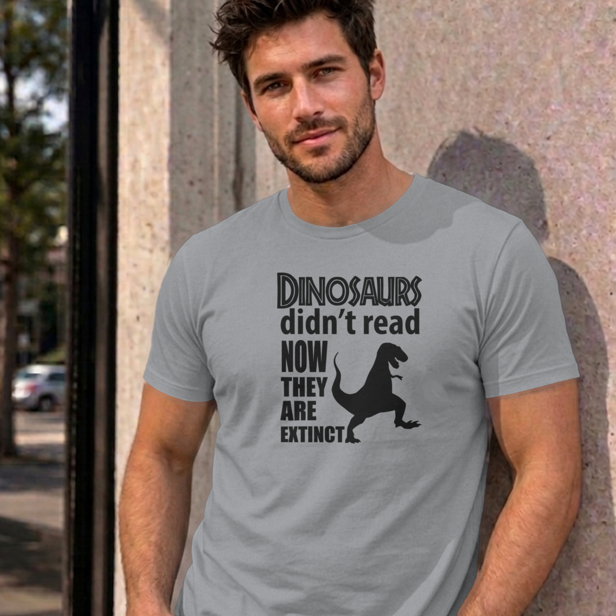 Man wearing the sport grey Dinosaurs Didn't Read graphic tee