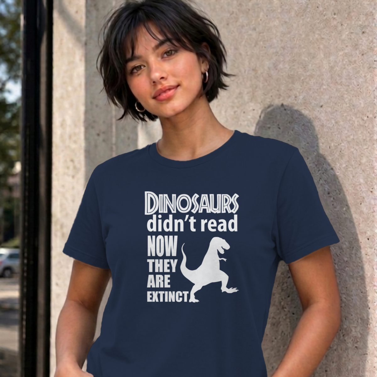 Woman wearing the navy Dinosaurs Didn't Read graphic tee