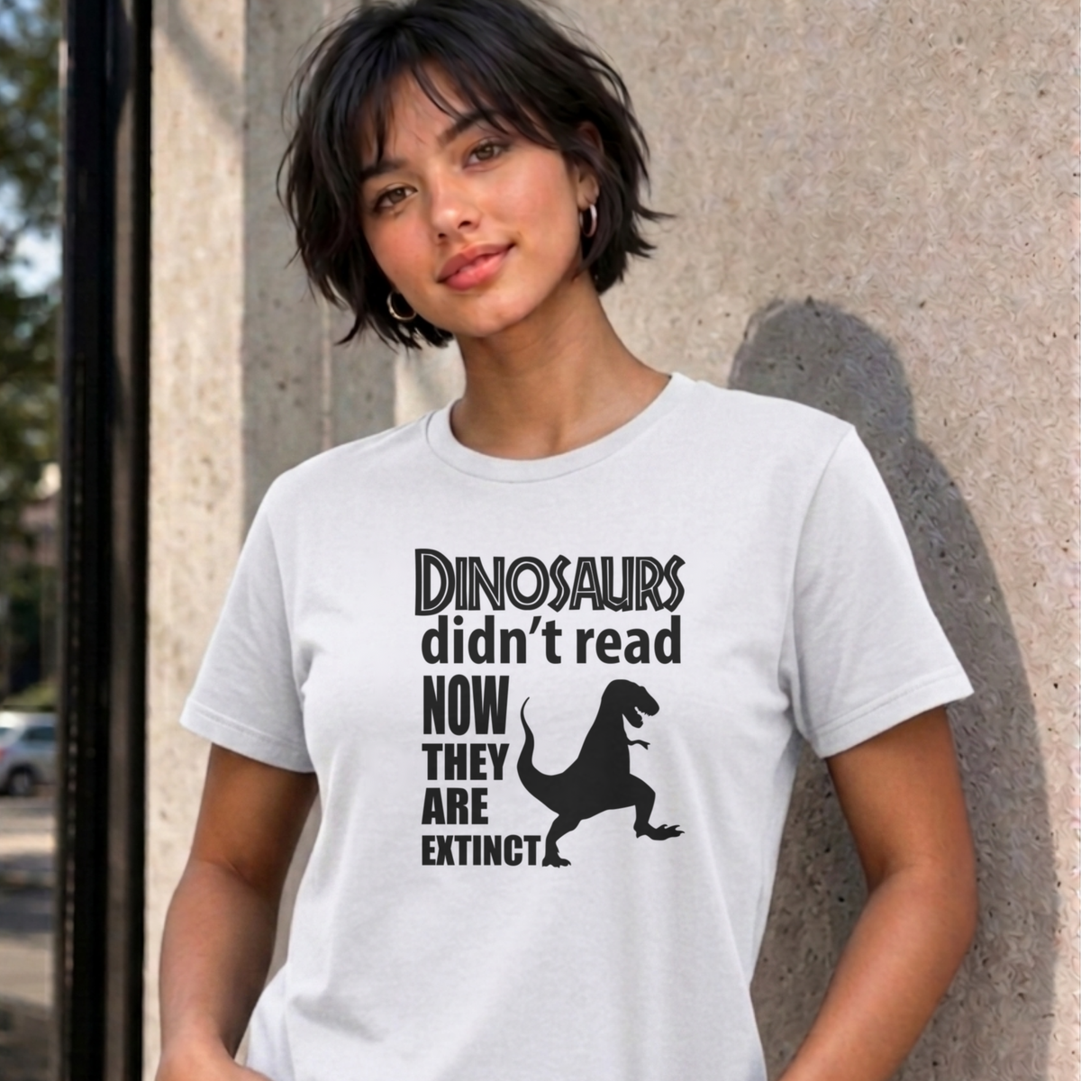 Woman wearing the white Dinosaurs Didn't Read graphic tee