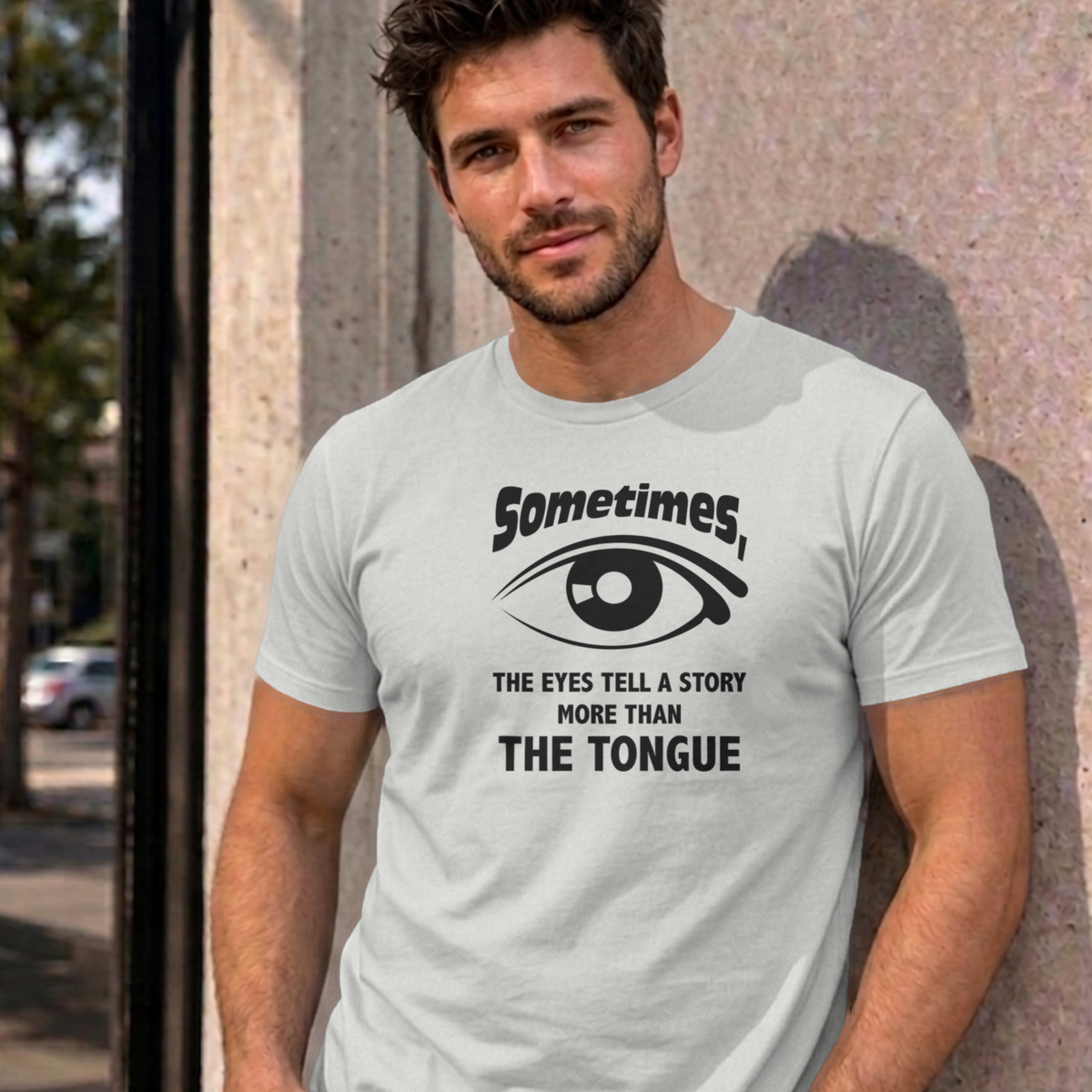 Man wearing the ash Eyes Tell a Story graphic tee