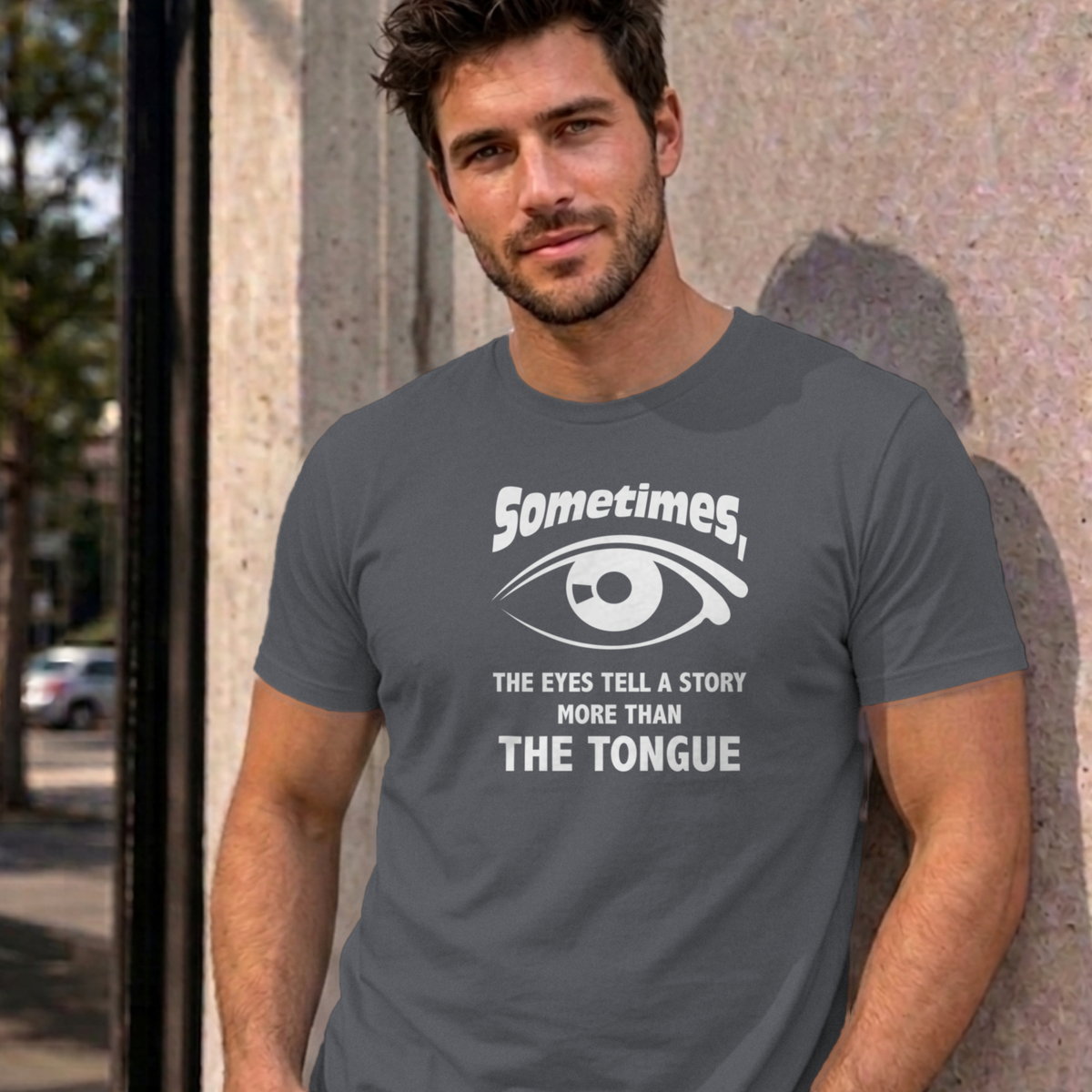 Man wearing the charcoal Eyes Tell a Story graphic tee