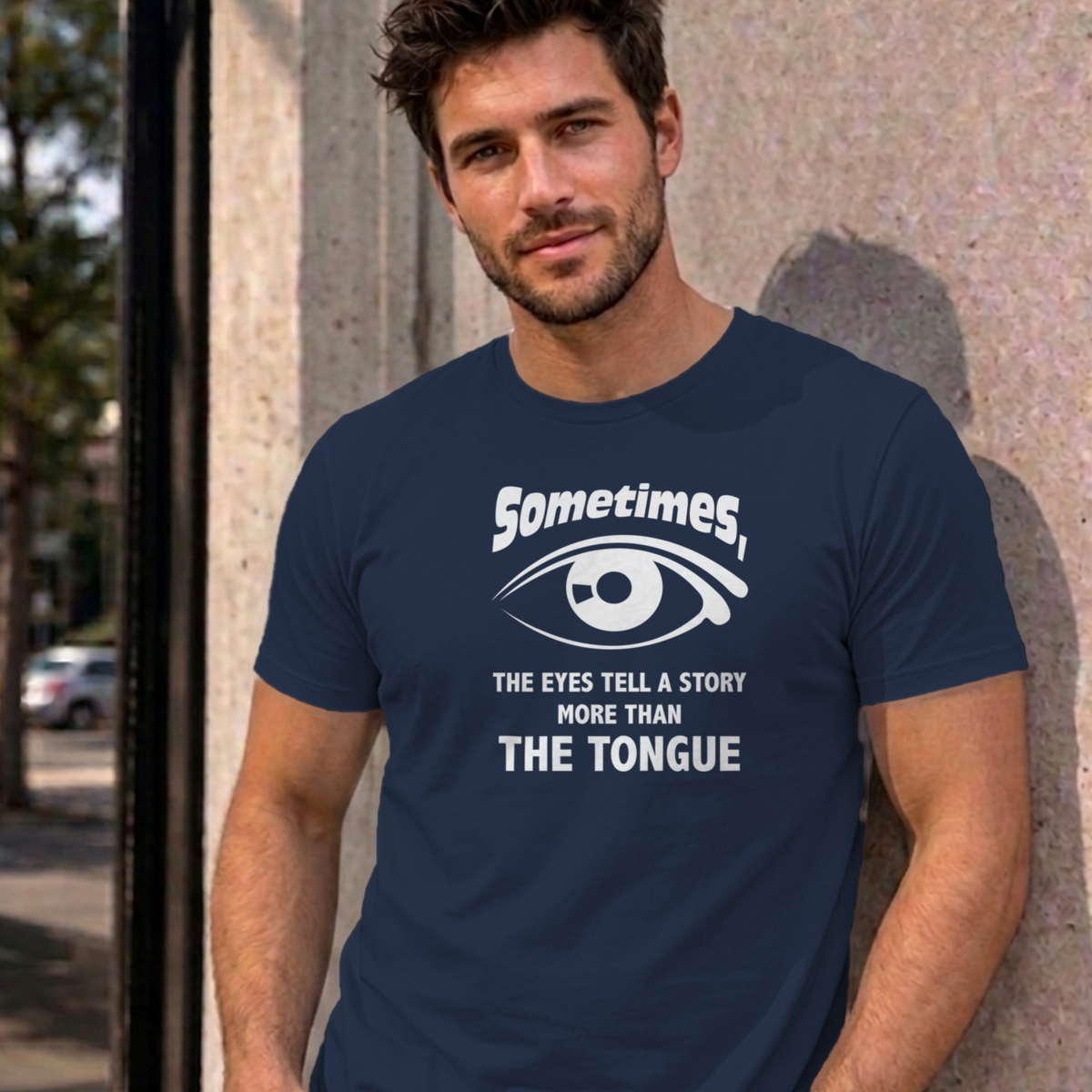 Man wearing the navy Eyes Tell a Story graphic tee