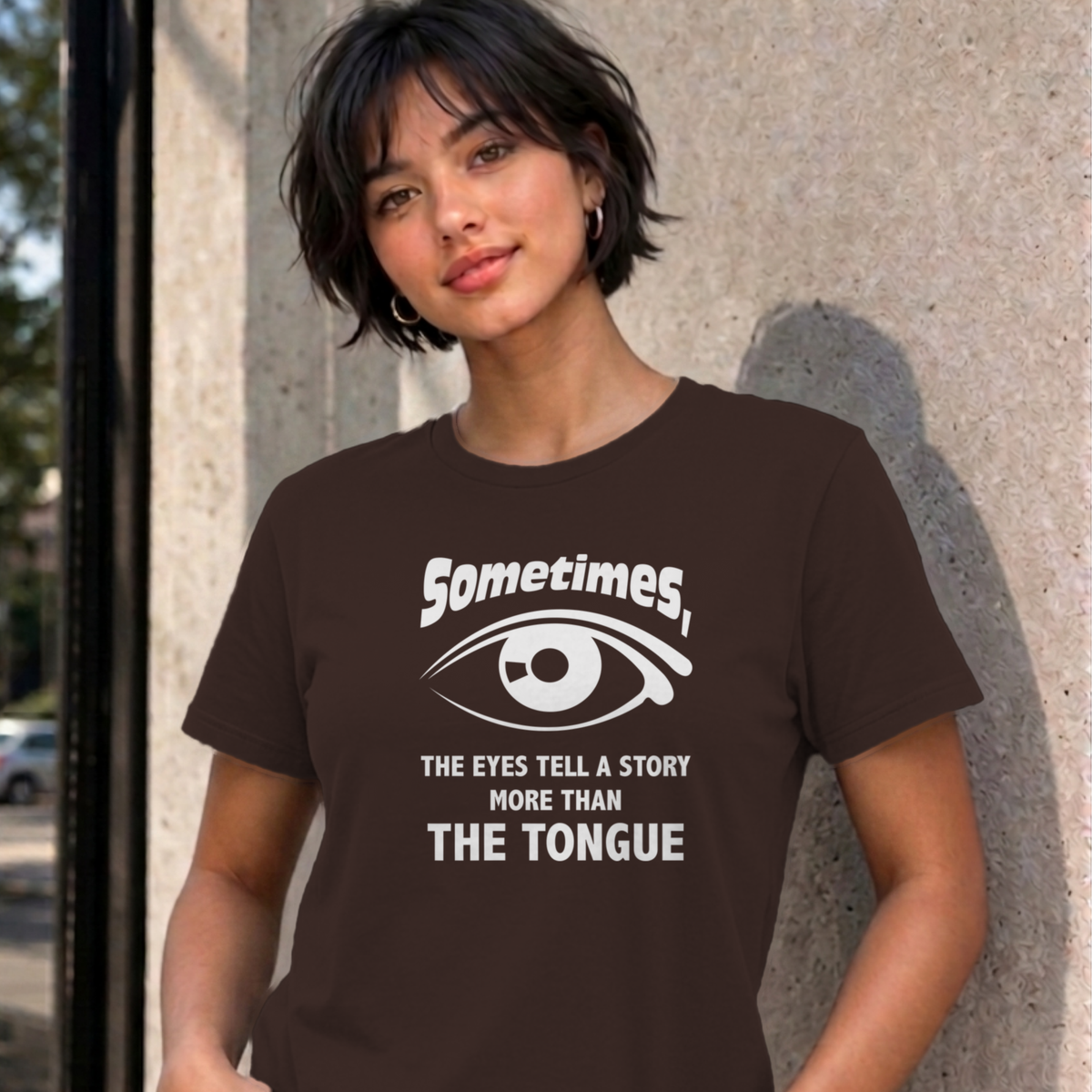 Woman wearing the dark chocolate Eyes Tell a Story graphic tee