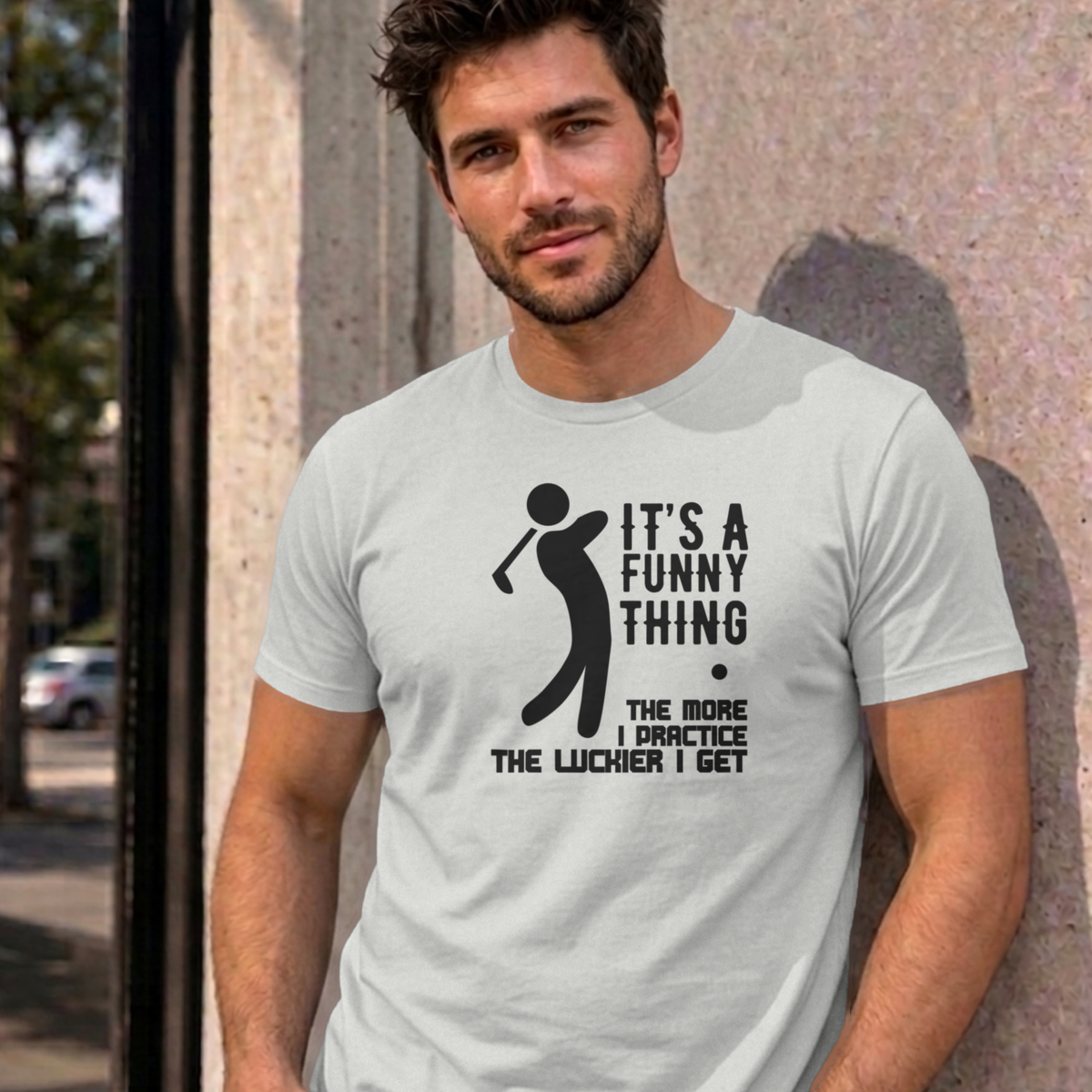 Man wearing the ash The More I Practice graphic tee