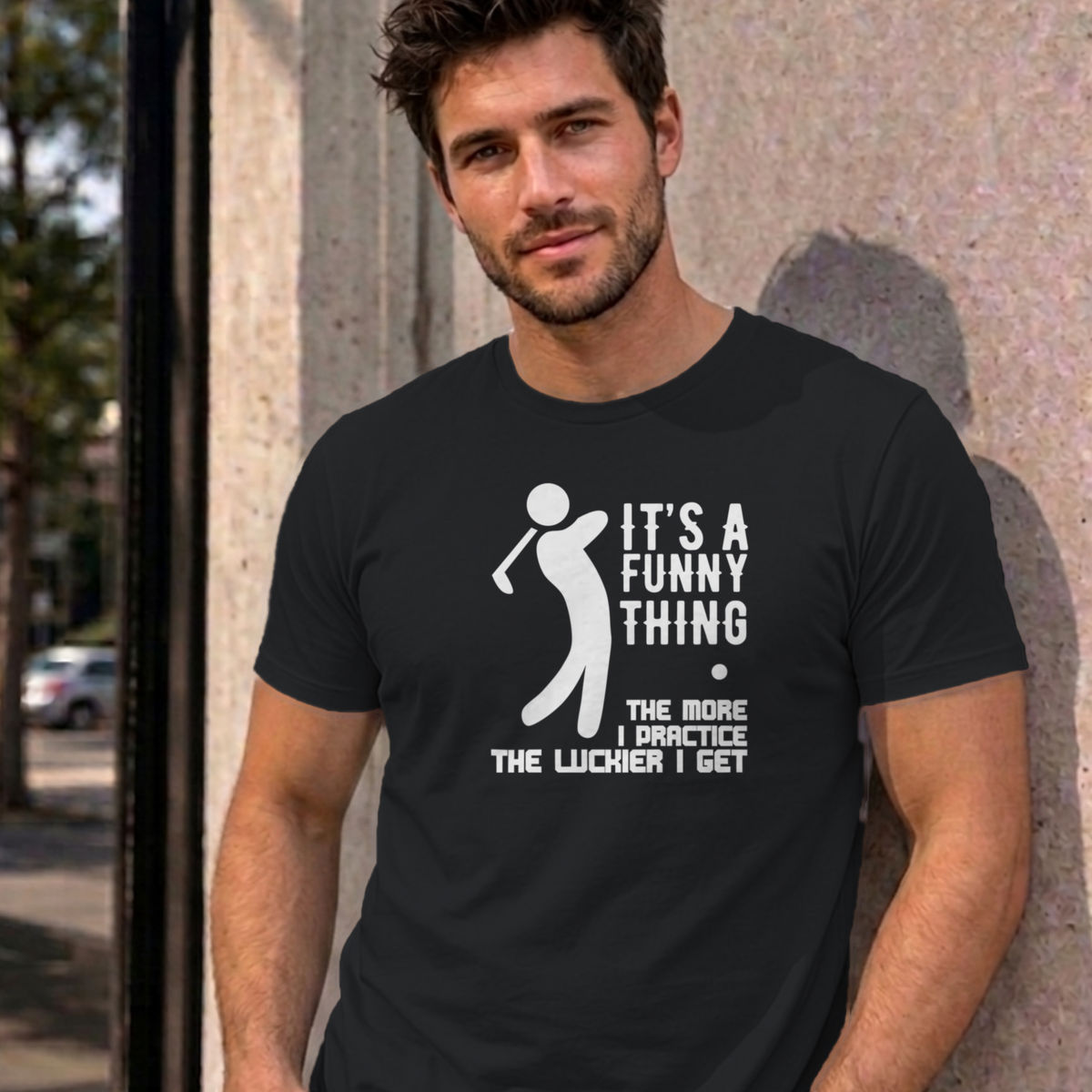 Man wearing the black The More I Practice graphic tee