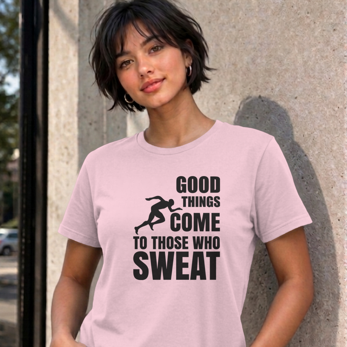Woman wearing the light pink Good Things Come to Those Who Sweat graphic tee