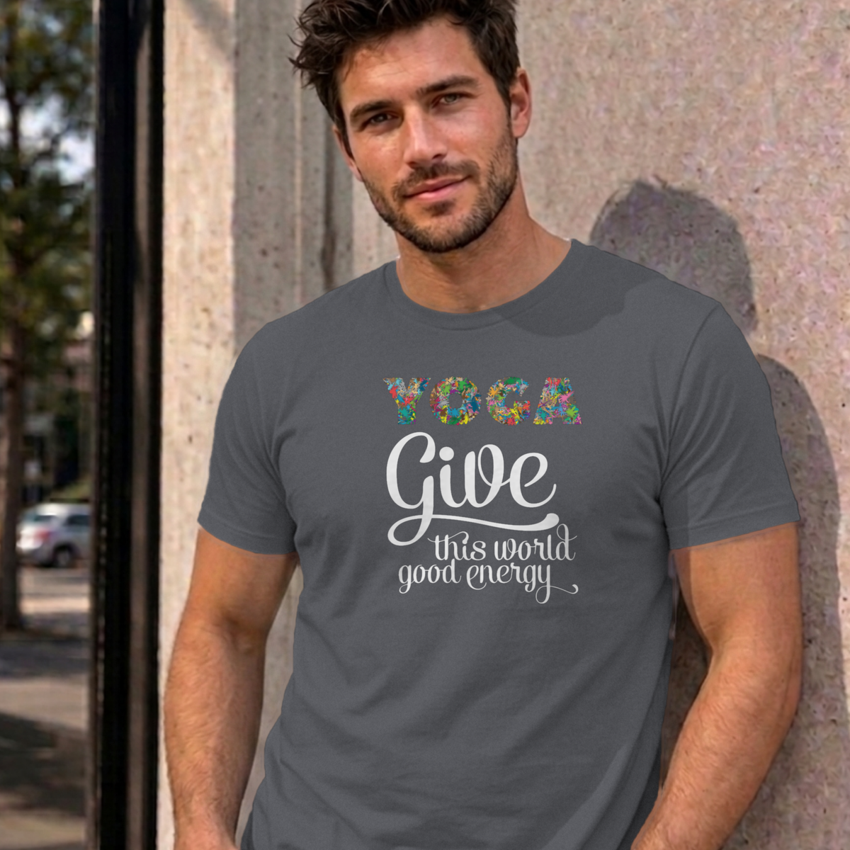 Man wearing the charcoal Give This World Good Energy graphic tee