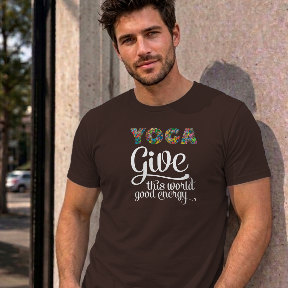 Man wearing the dark chocolate Give This World Good Energy graphic tee