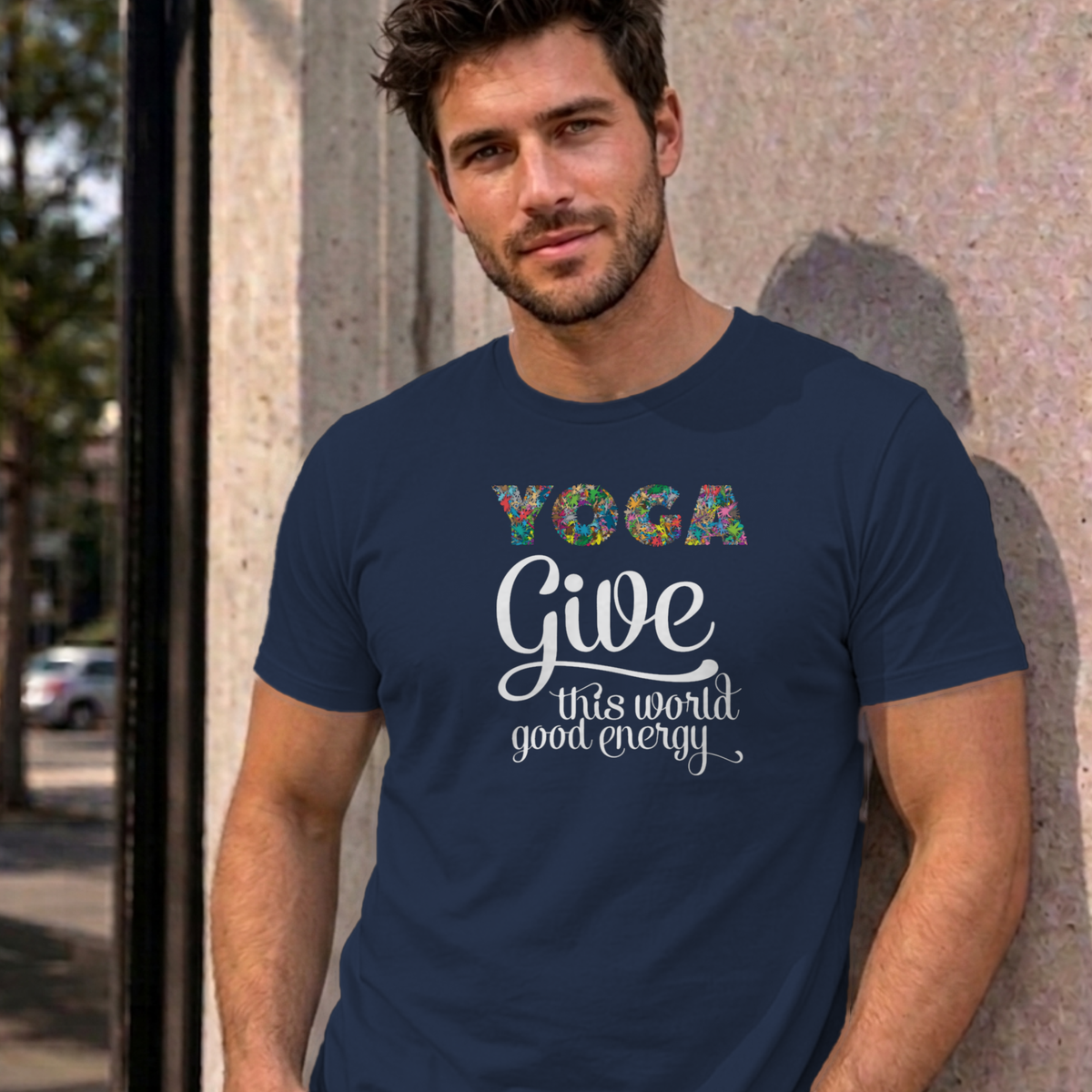 Man wearing the navy Give This World Good Energy graphic tee