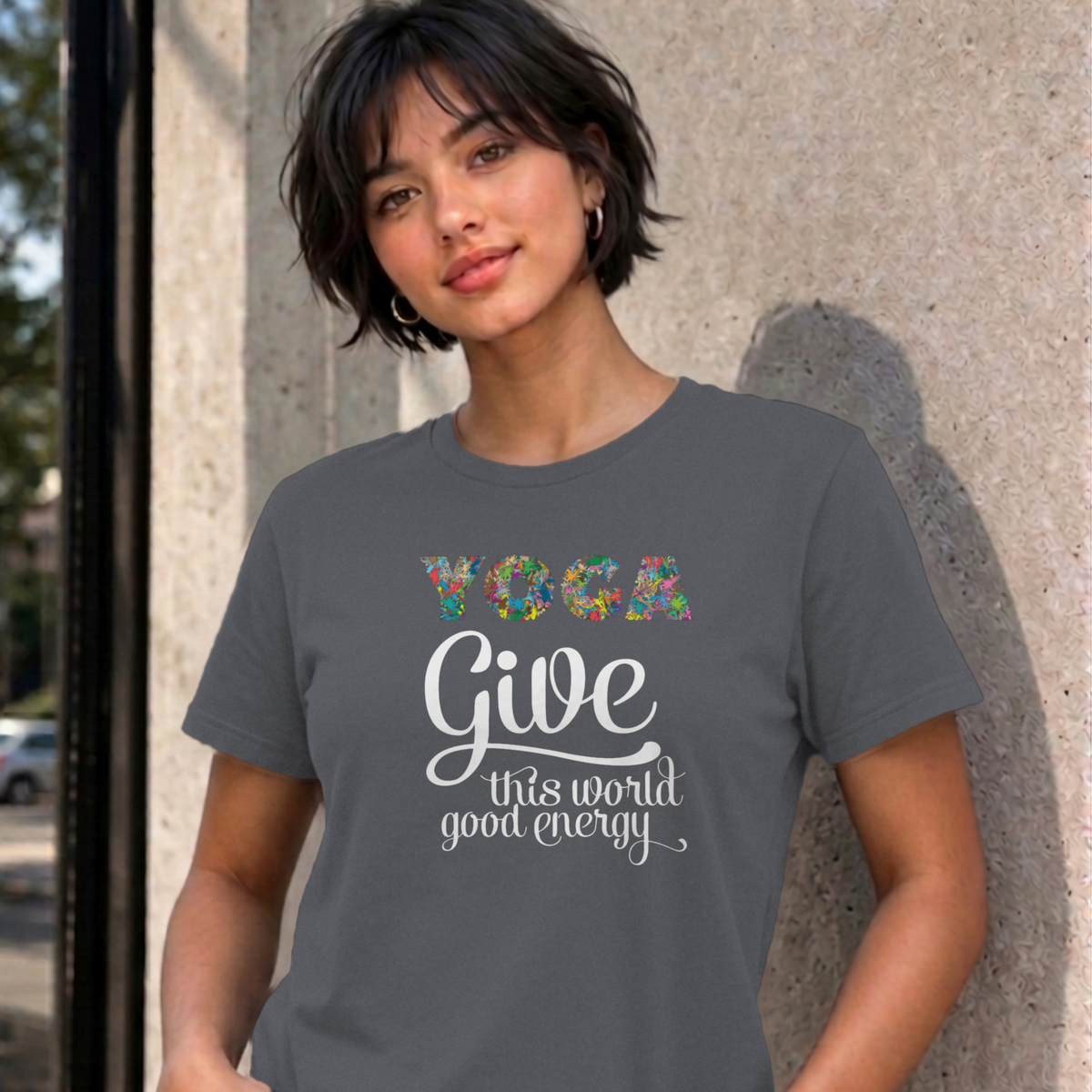 Woman wearing the charcoal Give This World Good Energy graphic tee