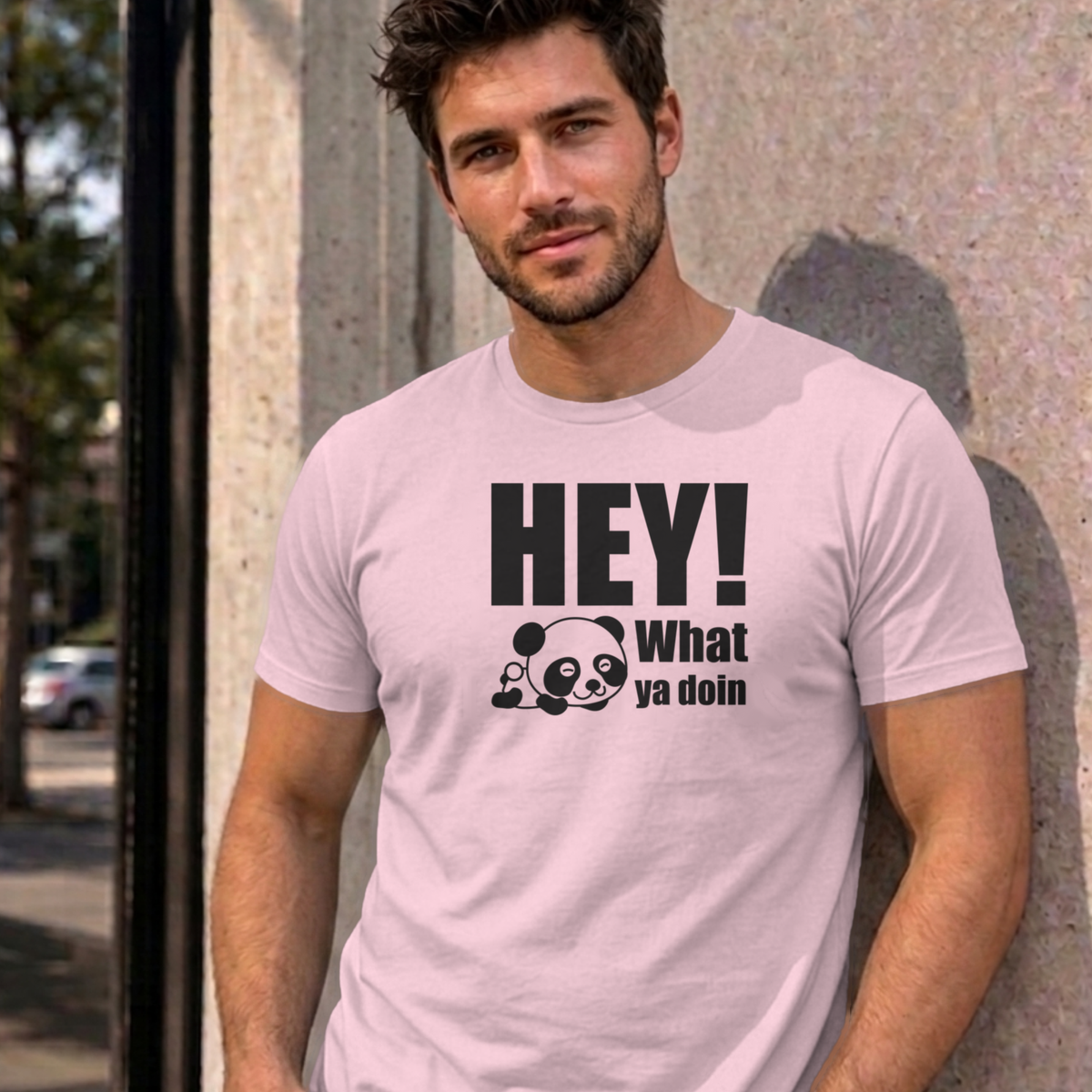 Man wearing the light pink Hey! What Ya Doin graphic tee