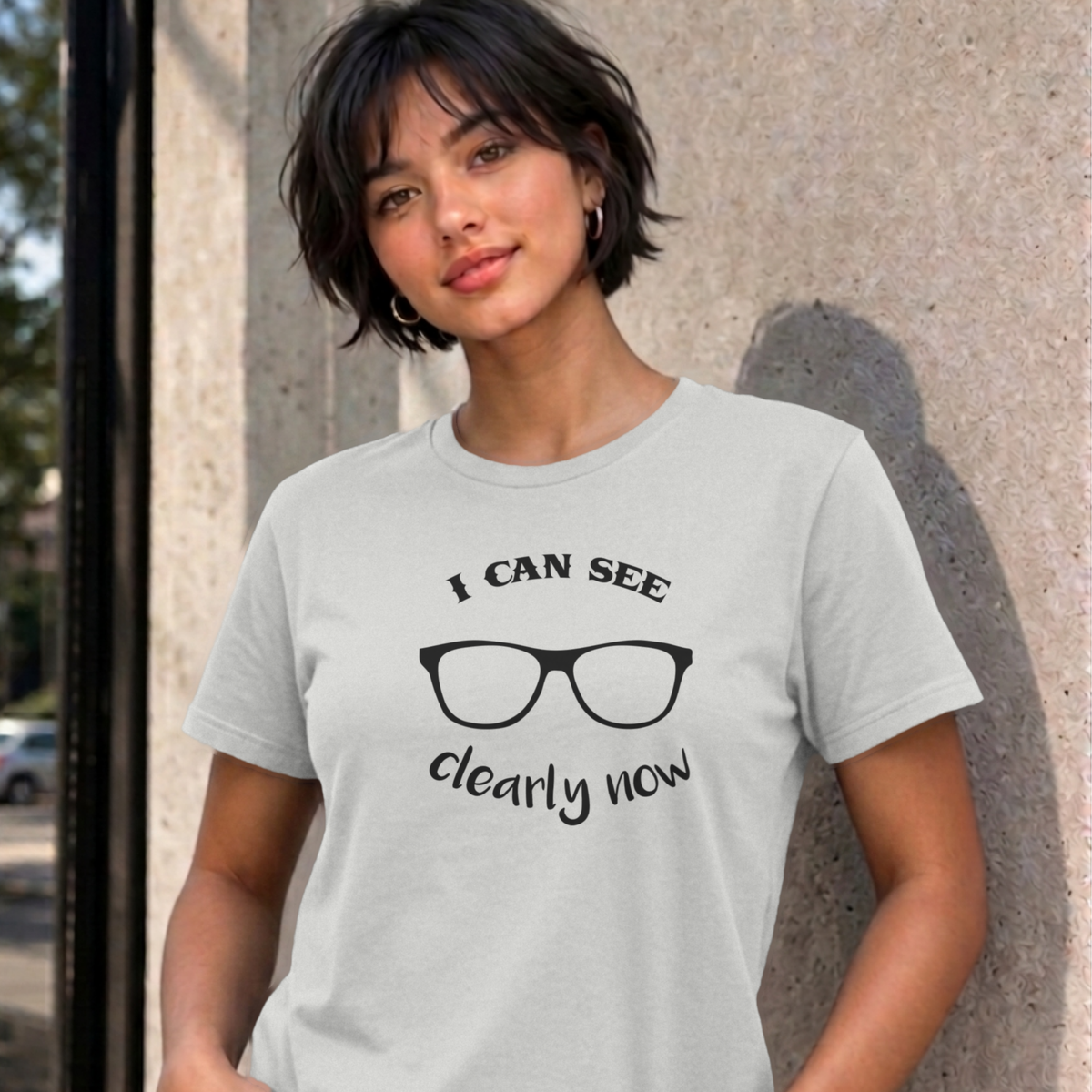 Woman wearing the ash I Can See Clearly Now graphic tee