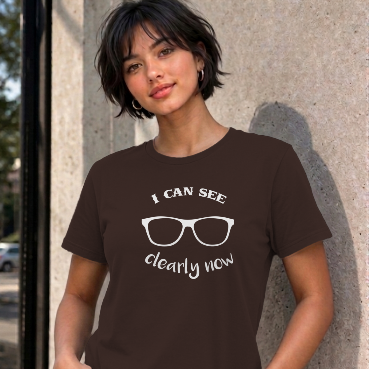 Woman wearing the dark chocolate I Can See Clearly Now graphic tee