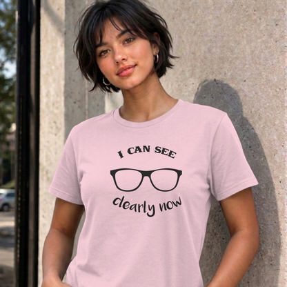Woman wearing the light pink I Can See Clearly Now graphic tee