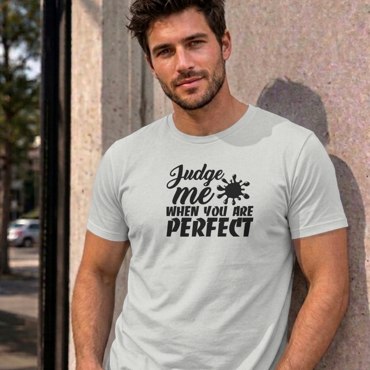 Man wearing the ash Judge Me When You Are Perfect graphic tee