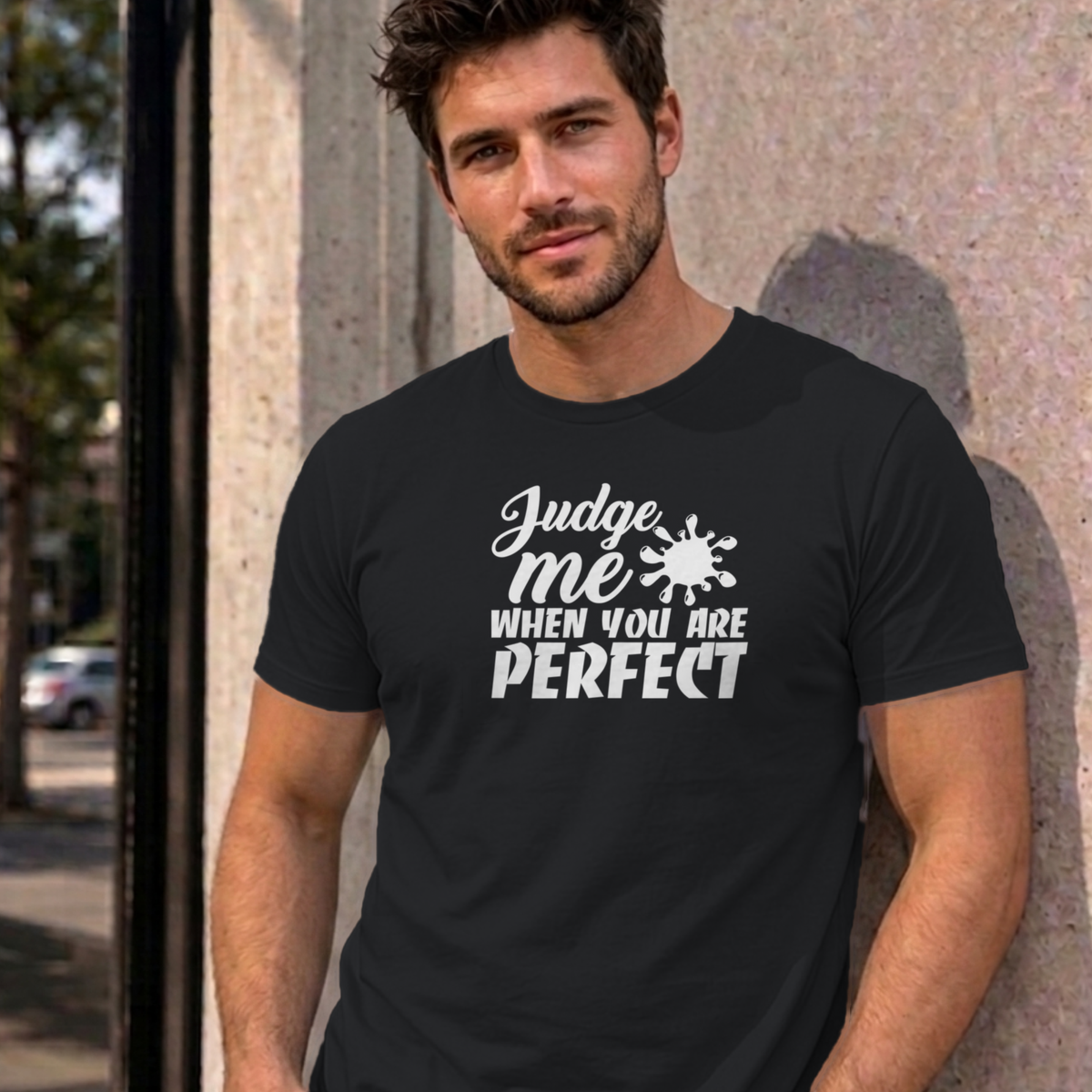 Man wearing the black Judge Me When You Are Perfect graphic tee