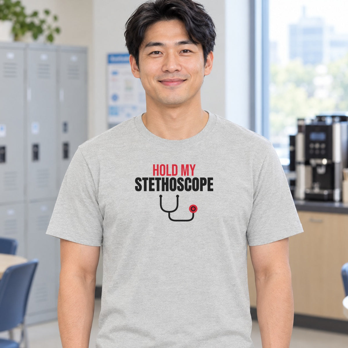 Man wearing the ash Hold My Stethoscope graphic tee