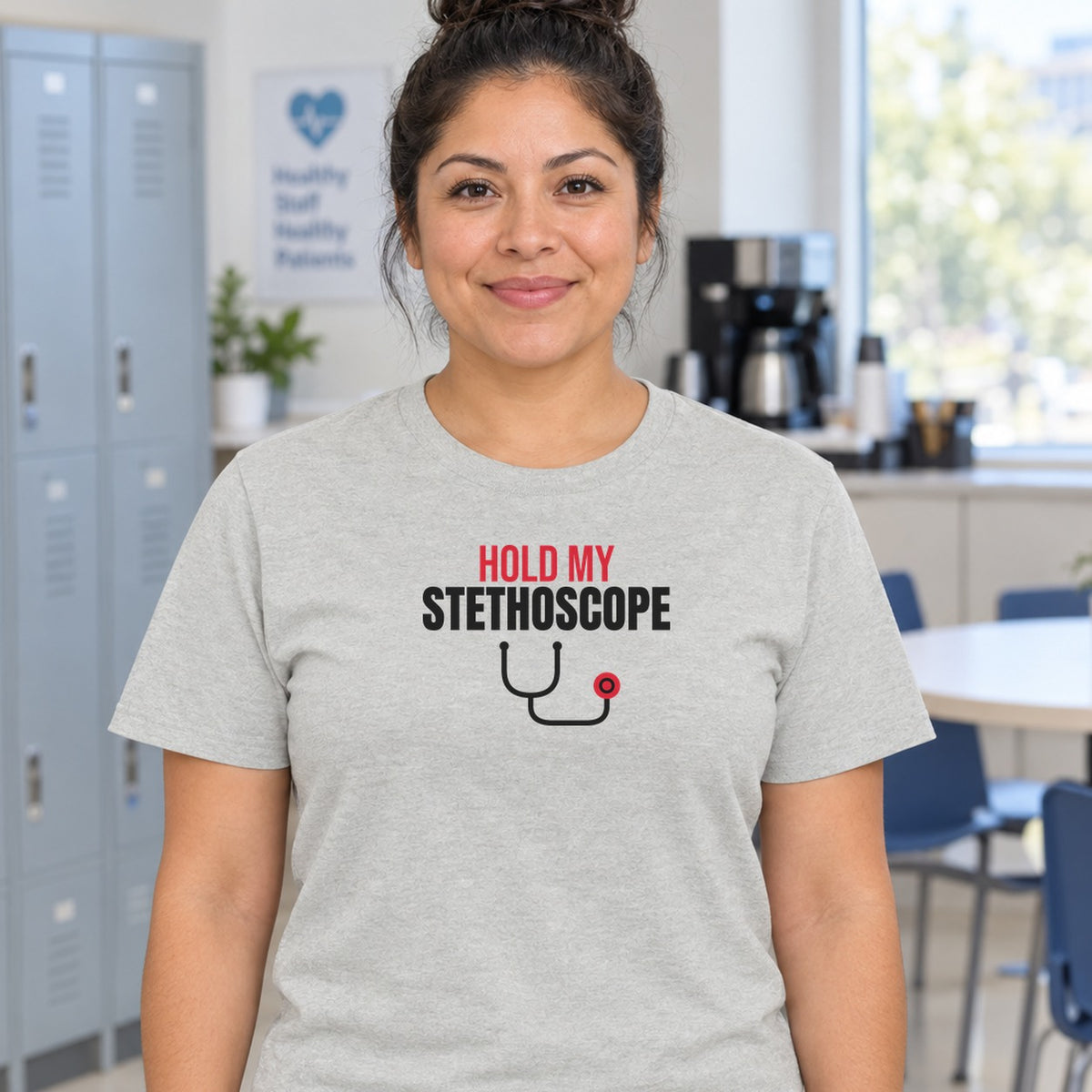 Woman wearing the ash Hold My Stethoscope graphic tee