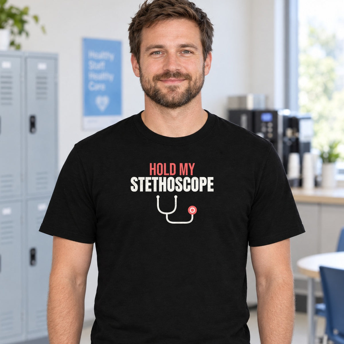 Man wearing the black Hold My Stethoscope graphic tee