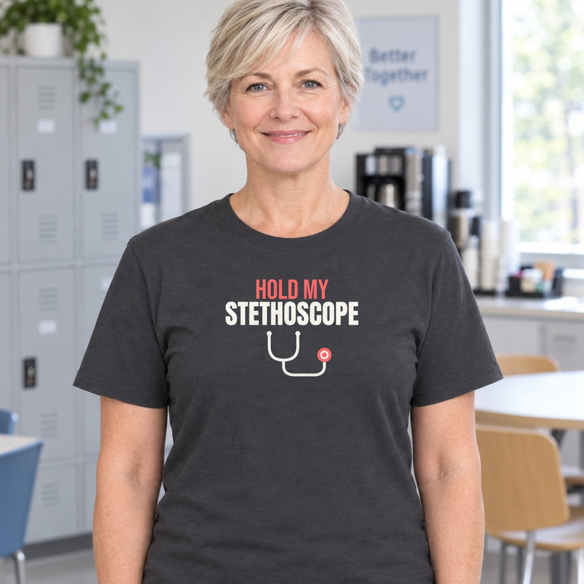 Woman wearing the charcoal Hold My Stethoscope graphic tee