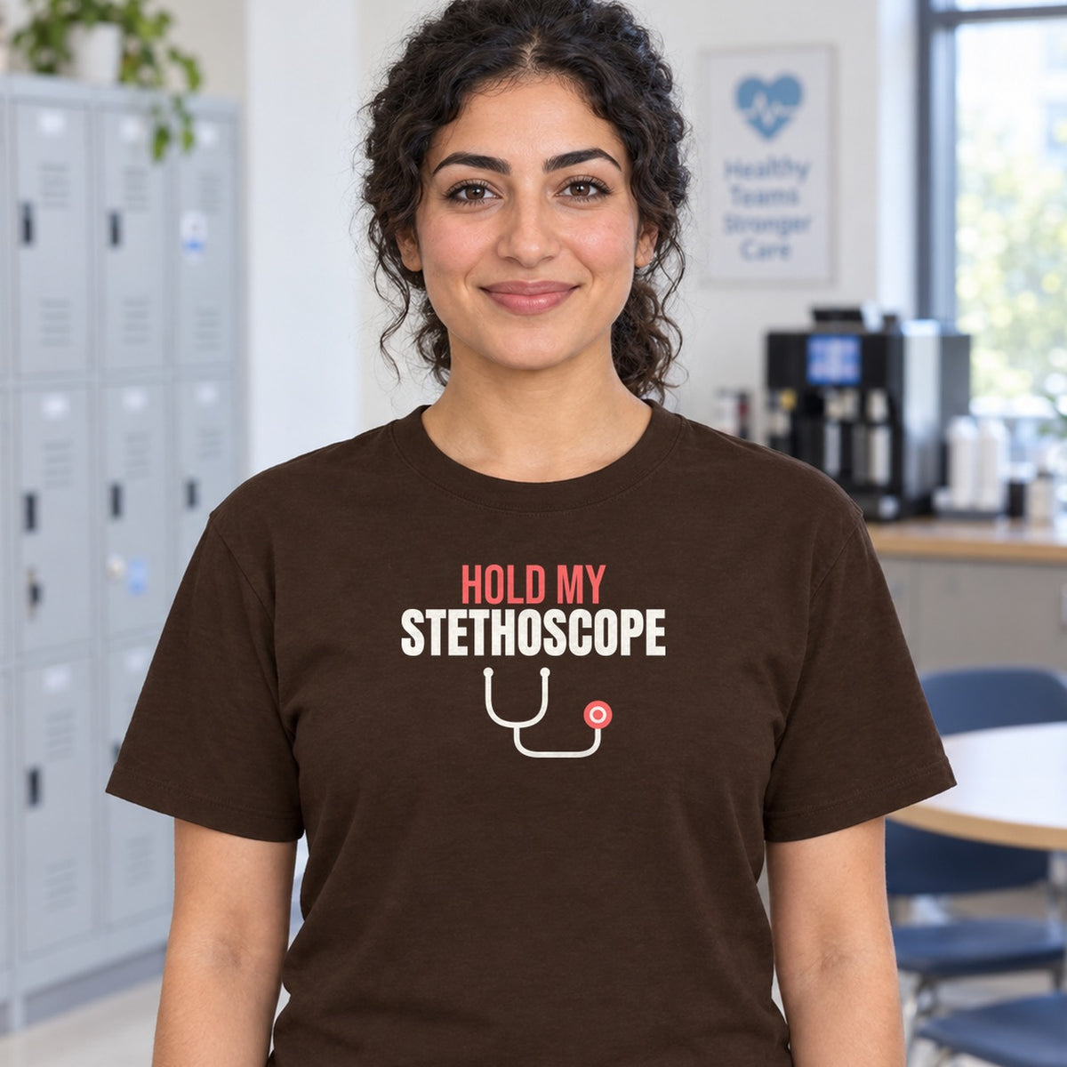 Woman wearing the dark chocolate Hold My Stethoscope graphic tee