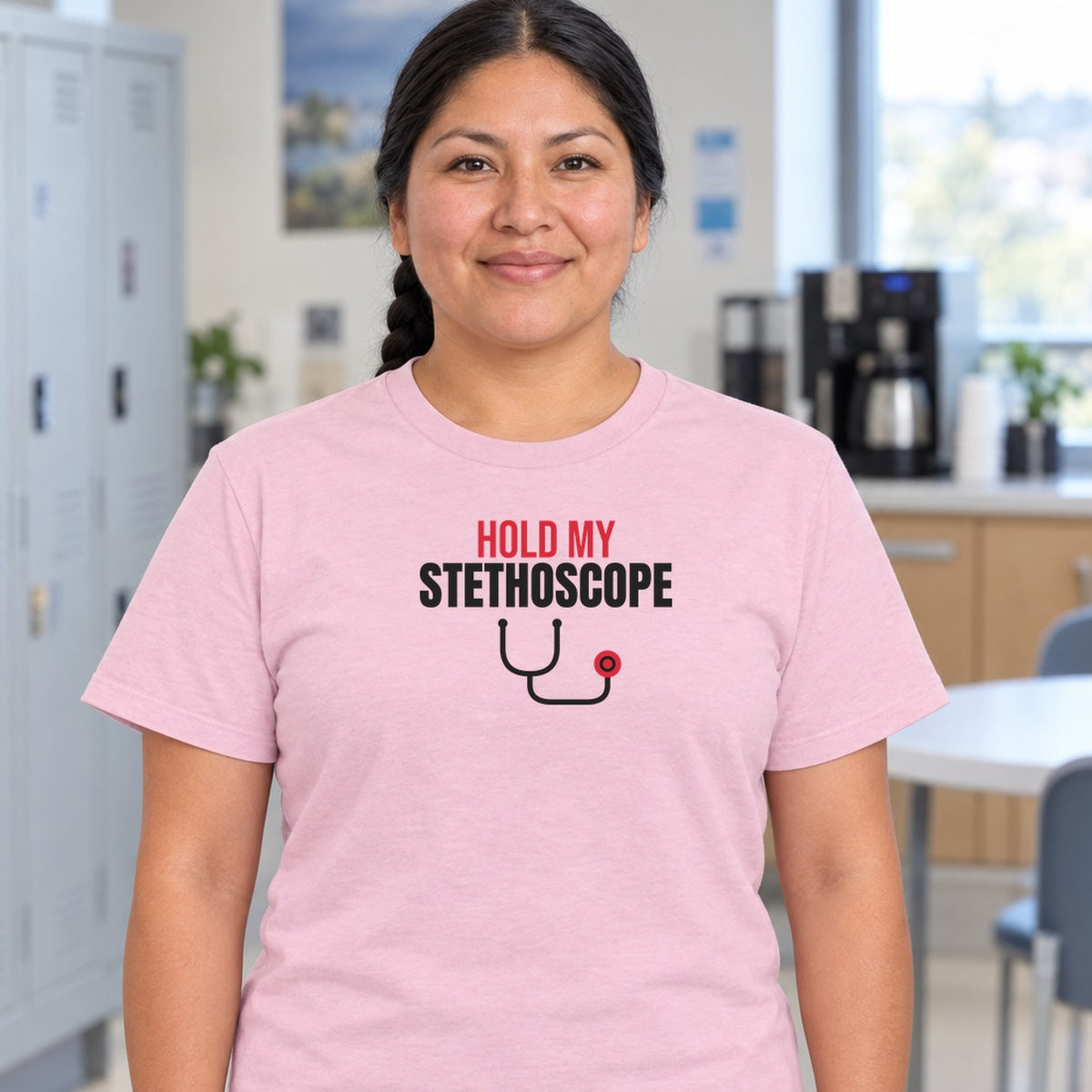 Woman wearing the light pink Hold My Stethoscope graphic tee