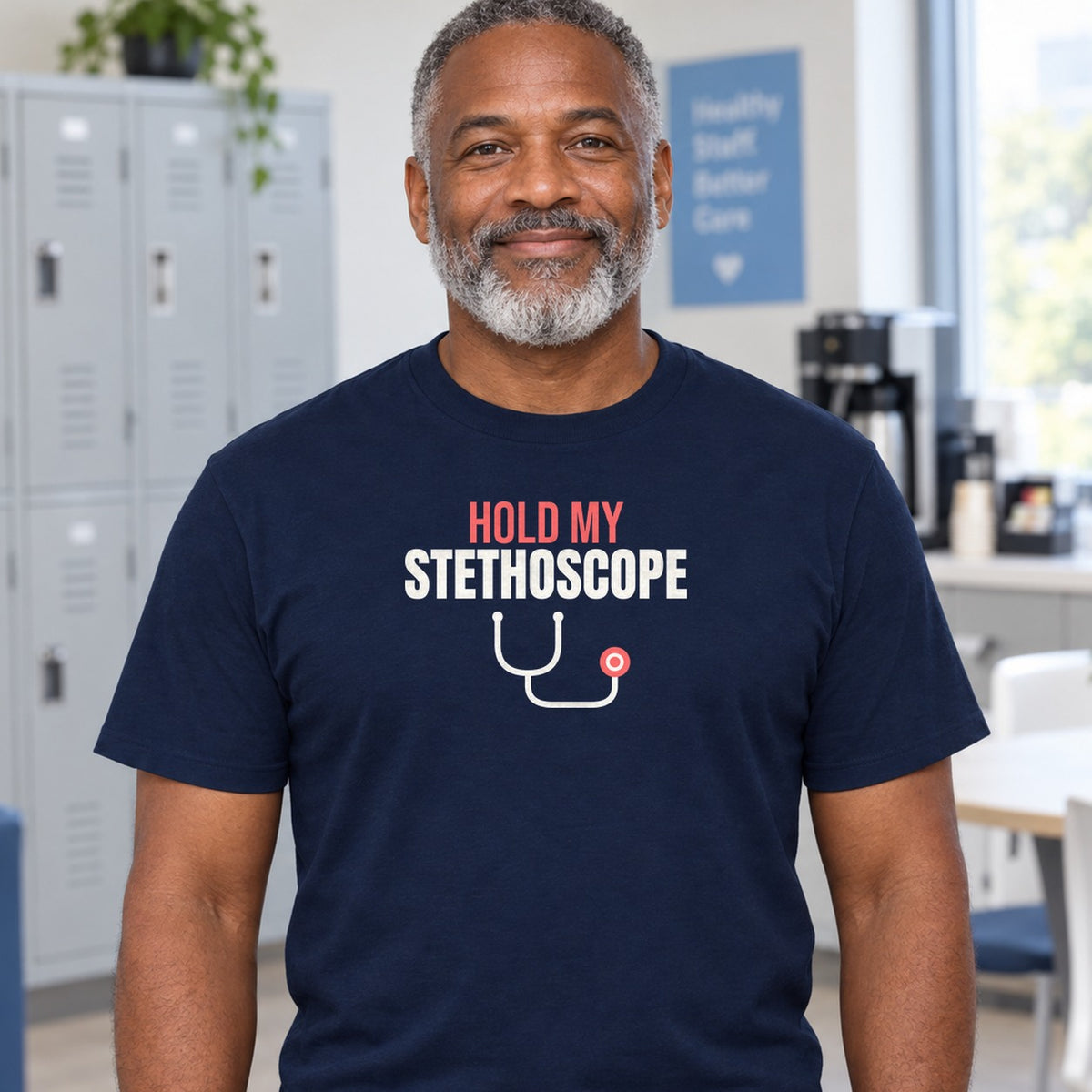 Man wearing the navy Hold My Stethoscope graphic tee