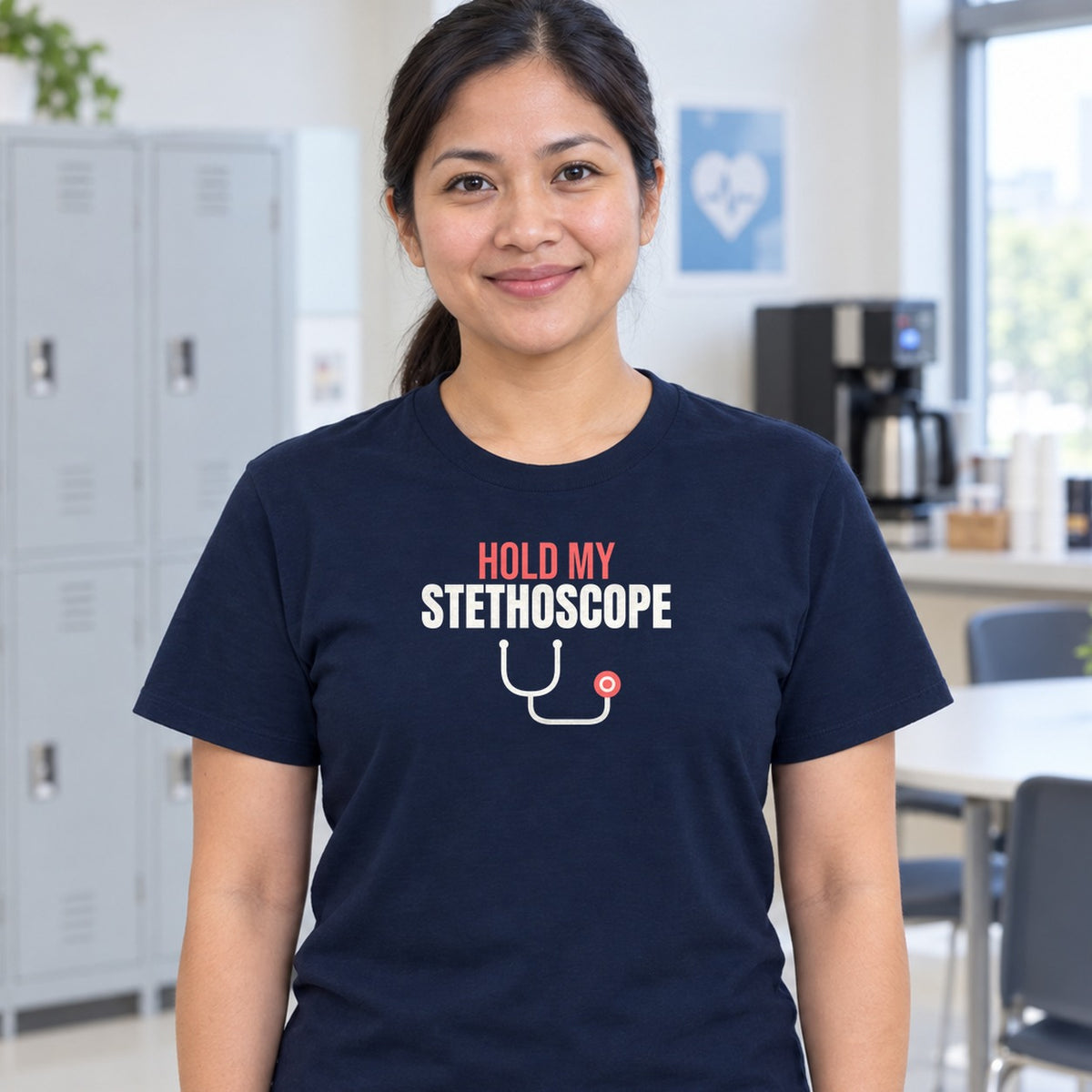 Woman wearing the navy Hold My Stethoscope graphic tee