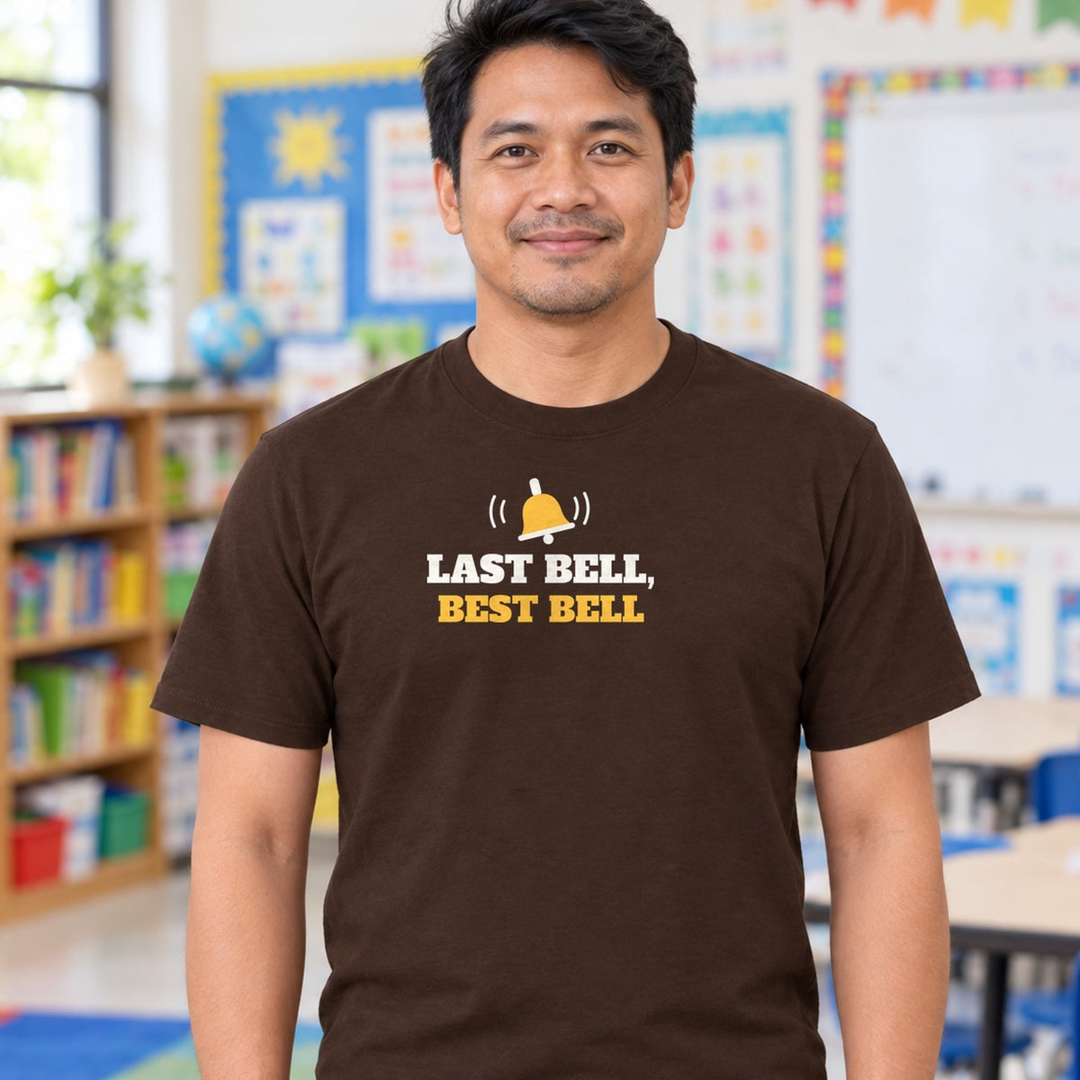 Man wearing the dark chocolate Last Bell, Best Bell graphic tee