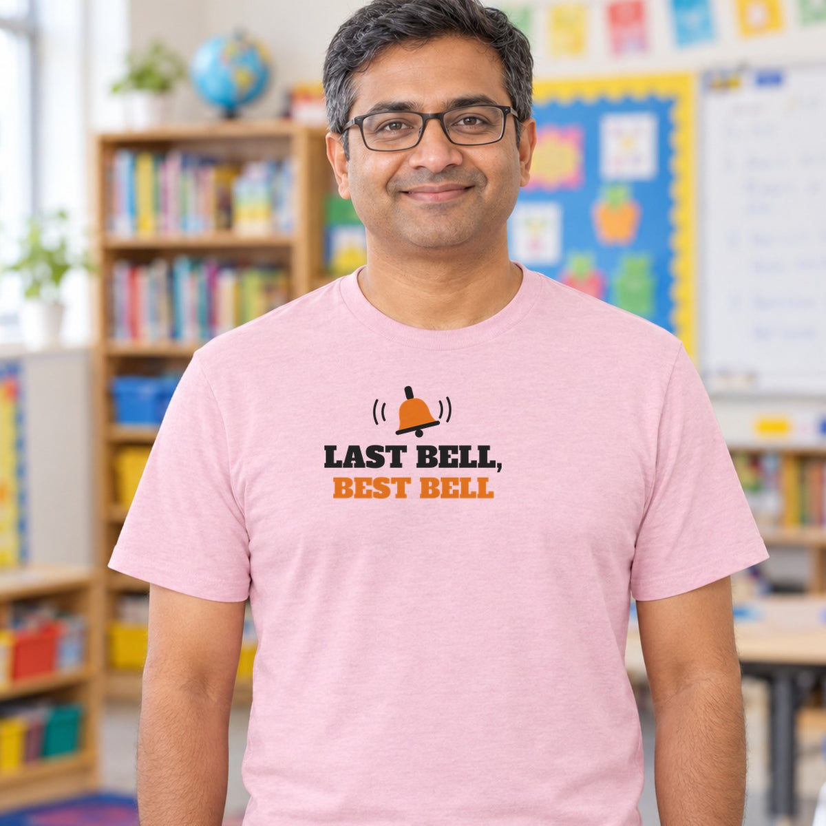Man wearing the light pink Last Bell, Best Bell graphic tee