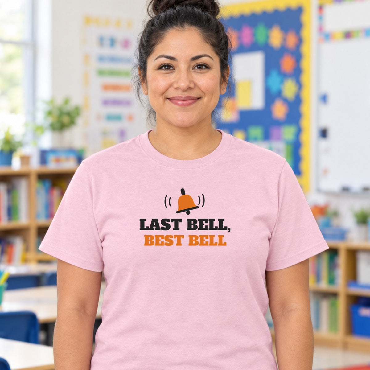 Woman wearing the light pink Last Bell, Best Bell graphic tee