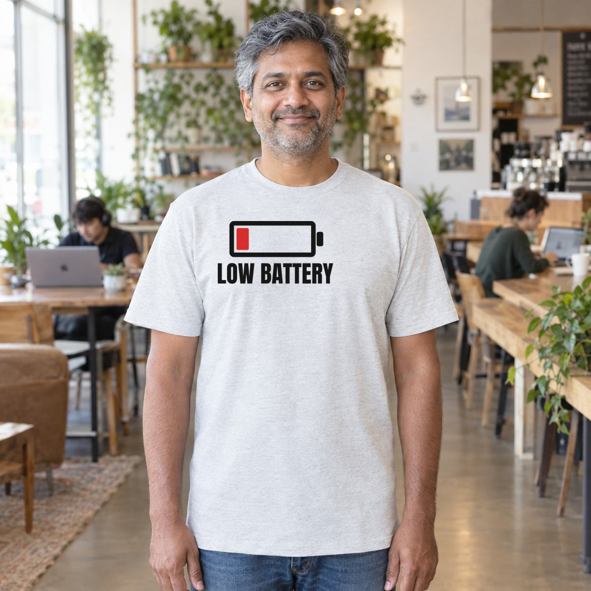 Man wearing the ash Low Battery graphic tee