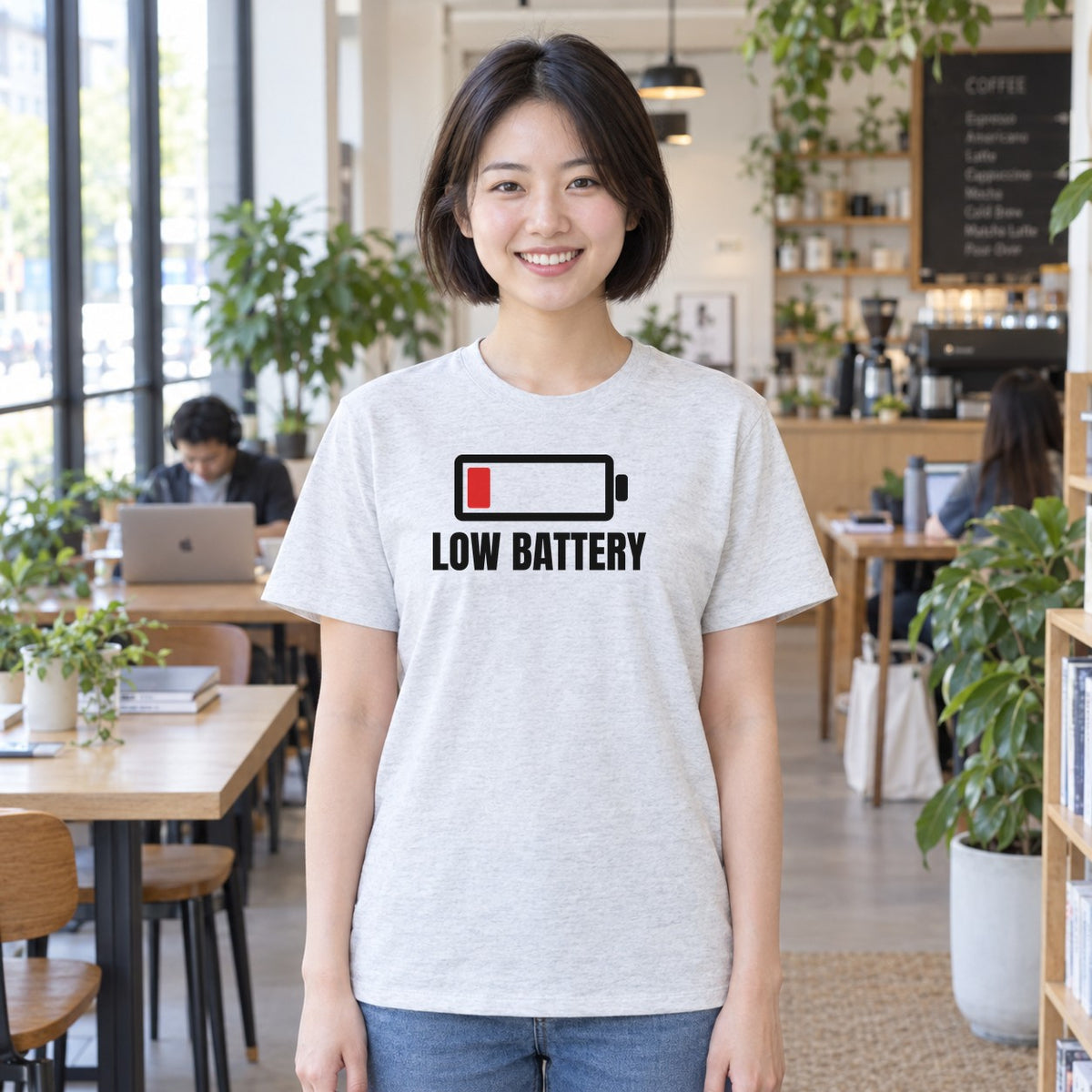 Woman wearing the ash Low Battery graphic tee