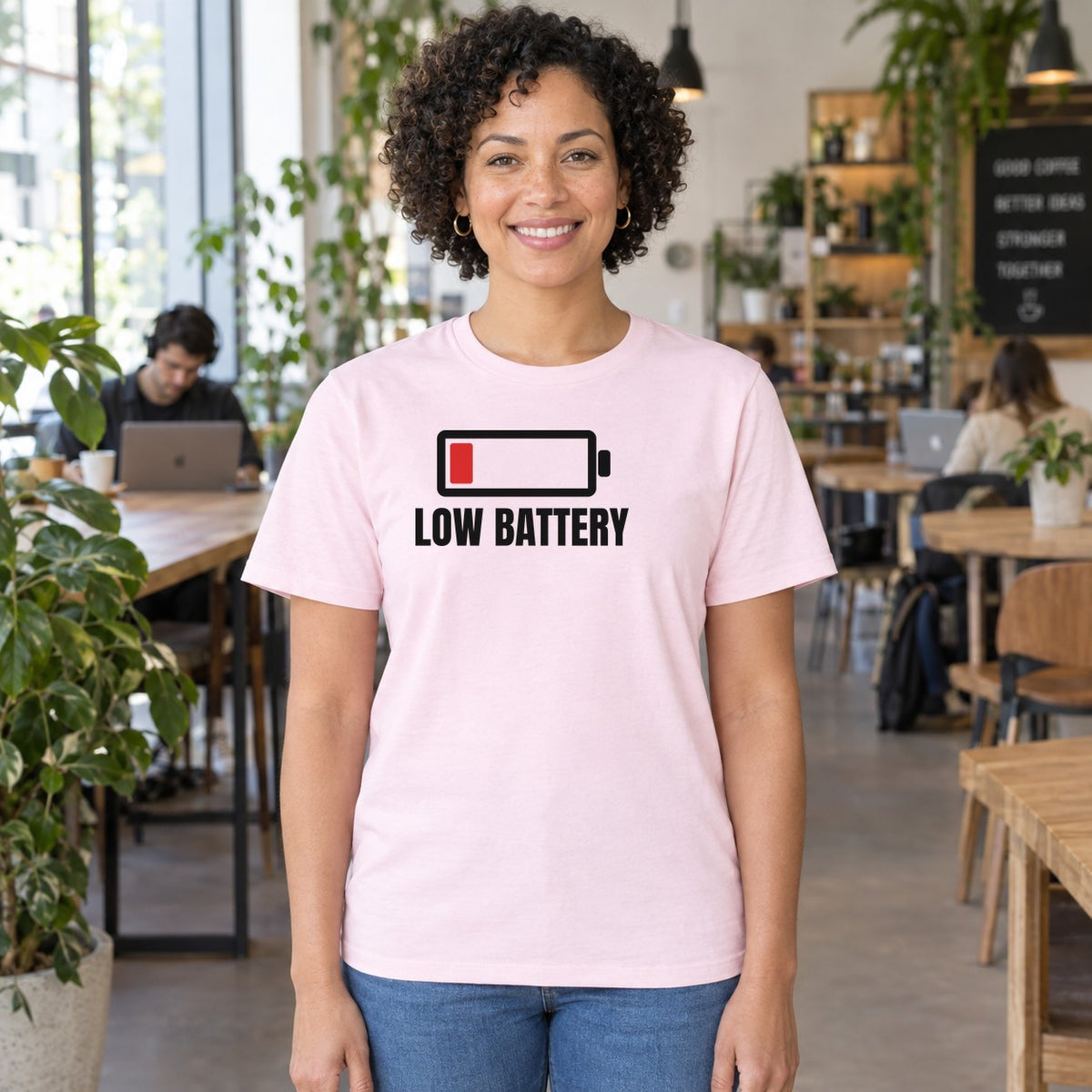 Woman wearing the light pink Low Battery graphic tee