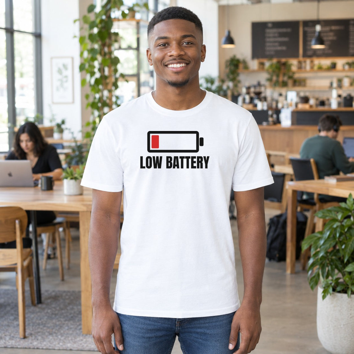 Man wearing the white Low Battery graphic tee