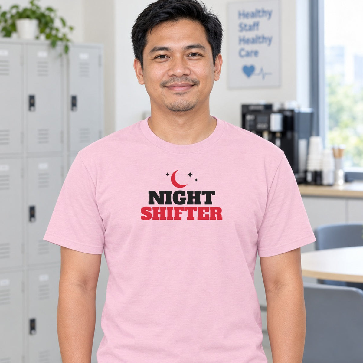 Man wearing the light pink Night Shifter graphic tee