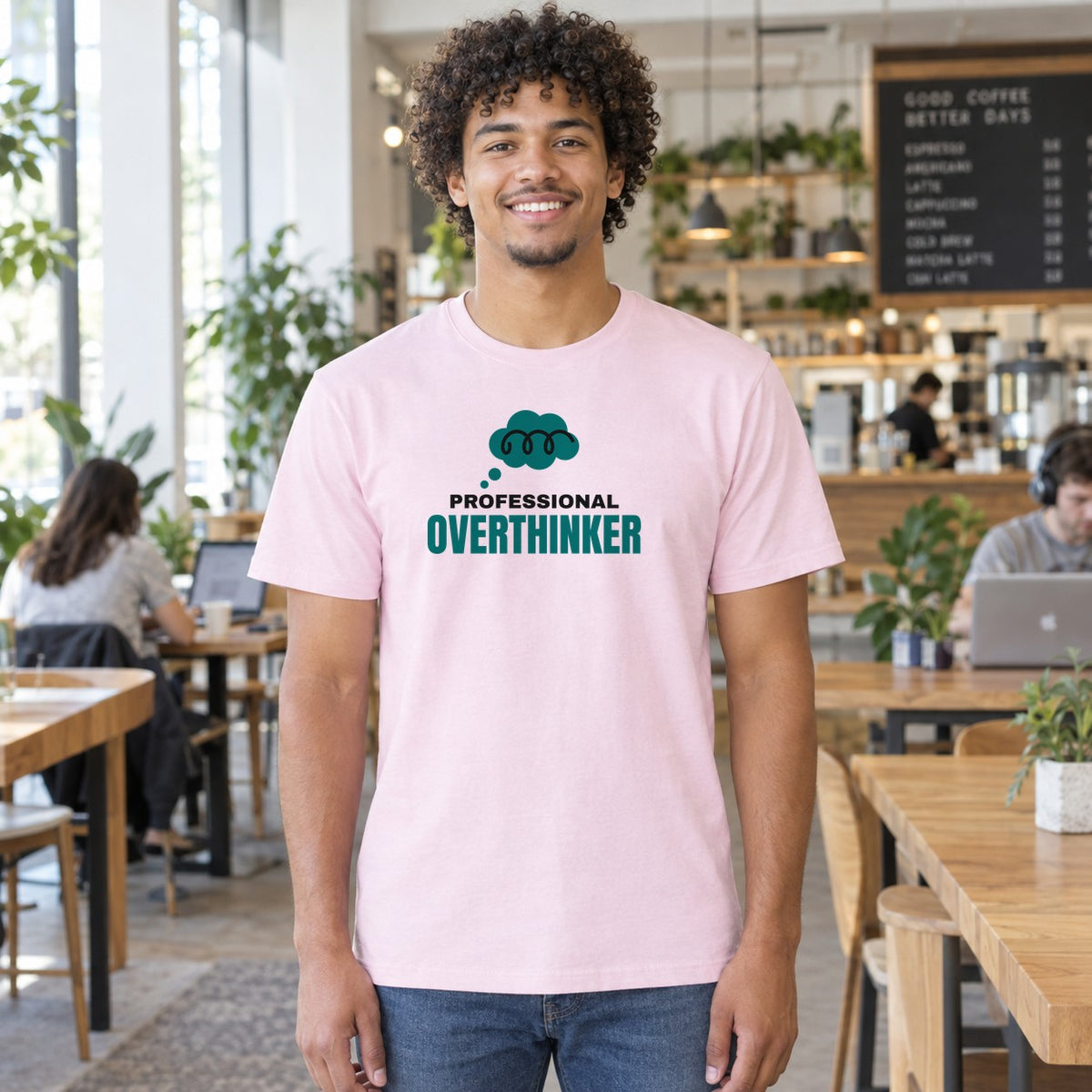 Man wearing the light pink Professional Overthinker graphic tee