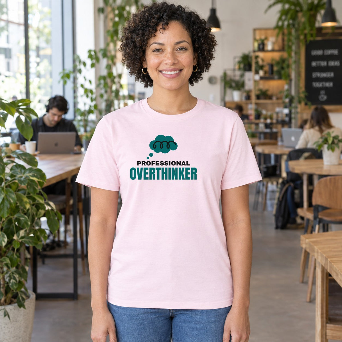 Woman wearing the light pink Professional Overthinker graphic tee
