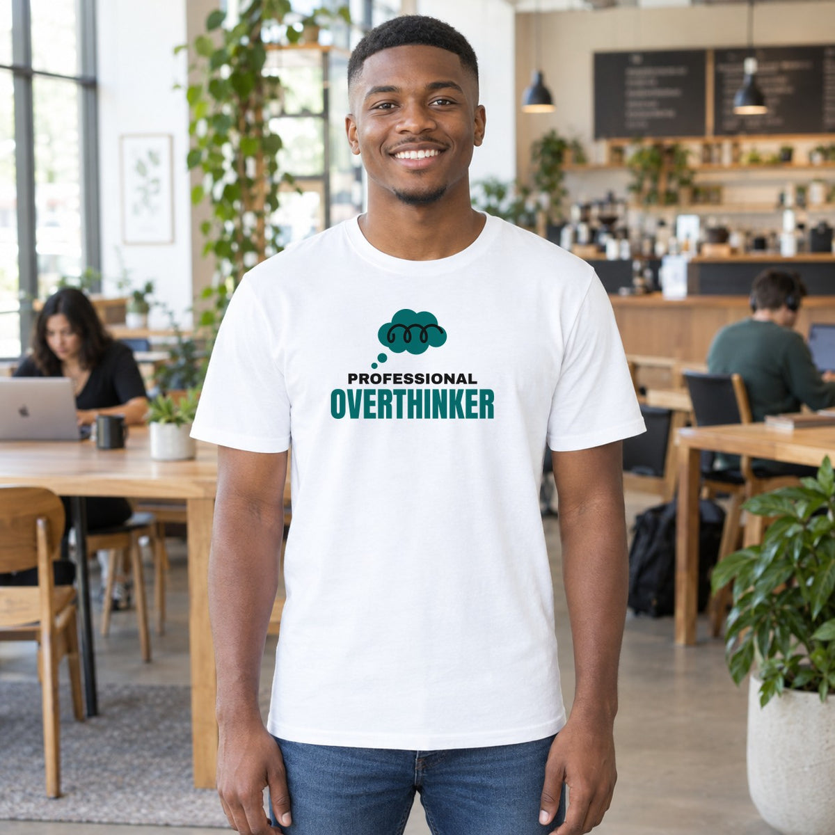 Man wearing the white Professional Overthinker graphic tee