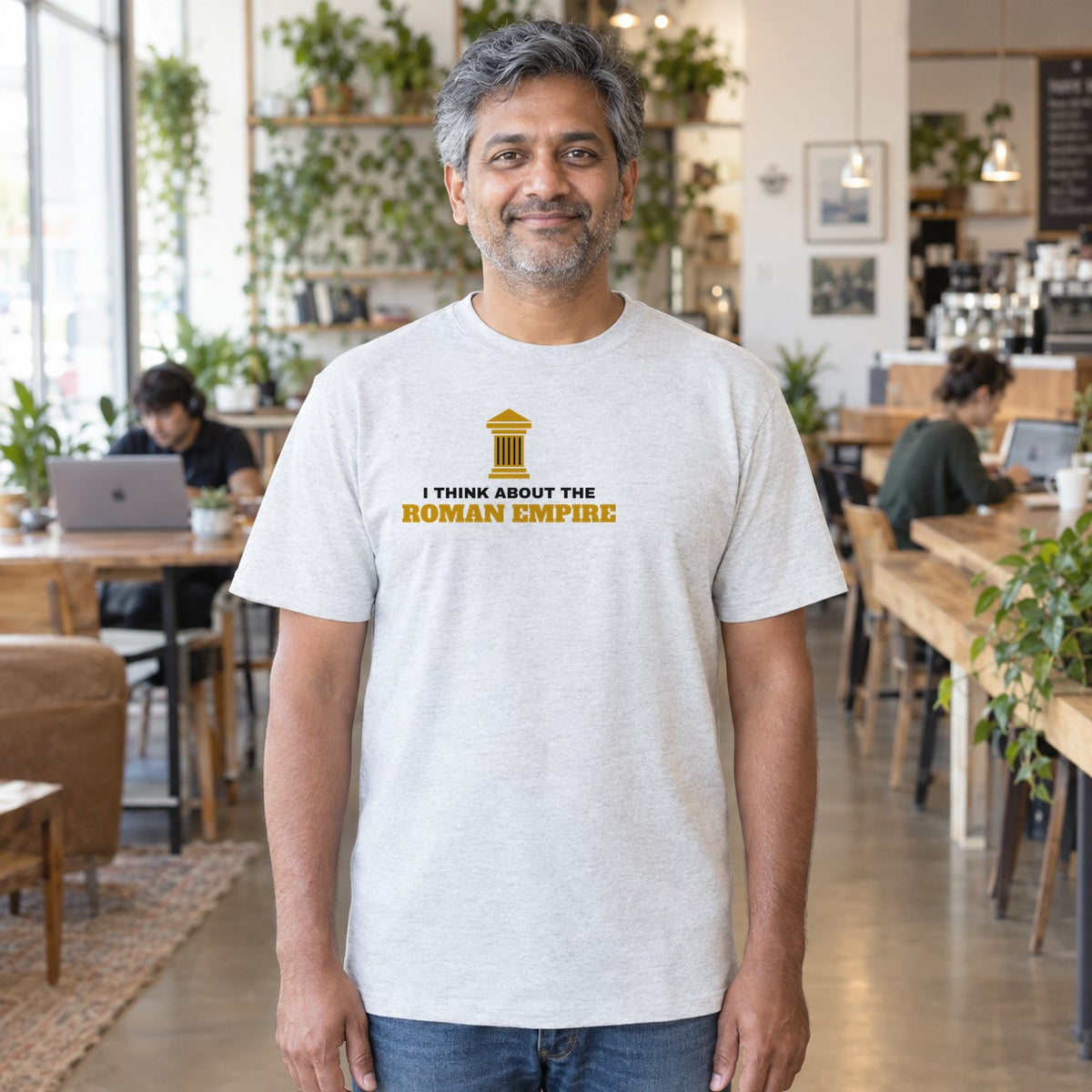 Man wearing the ash Roman Empire graphic tee